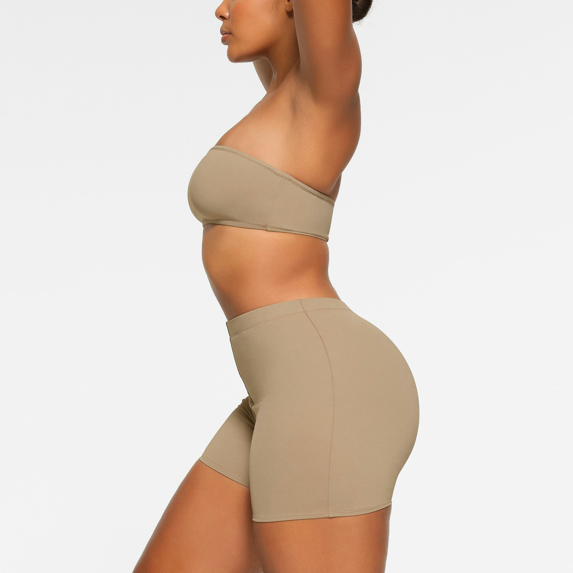 SWIM MID WAIST SHORT WORN BY A MODEL IN SIDE VIEW