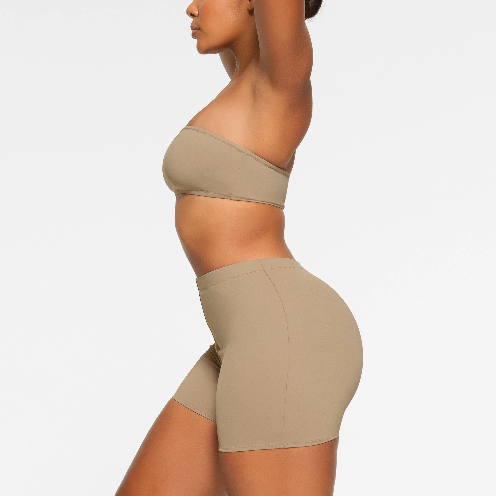 SWIM MID WAIST SHORT WORN BY A MODEL IN SIDE VIEW