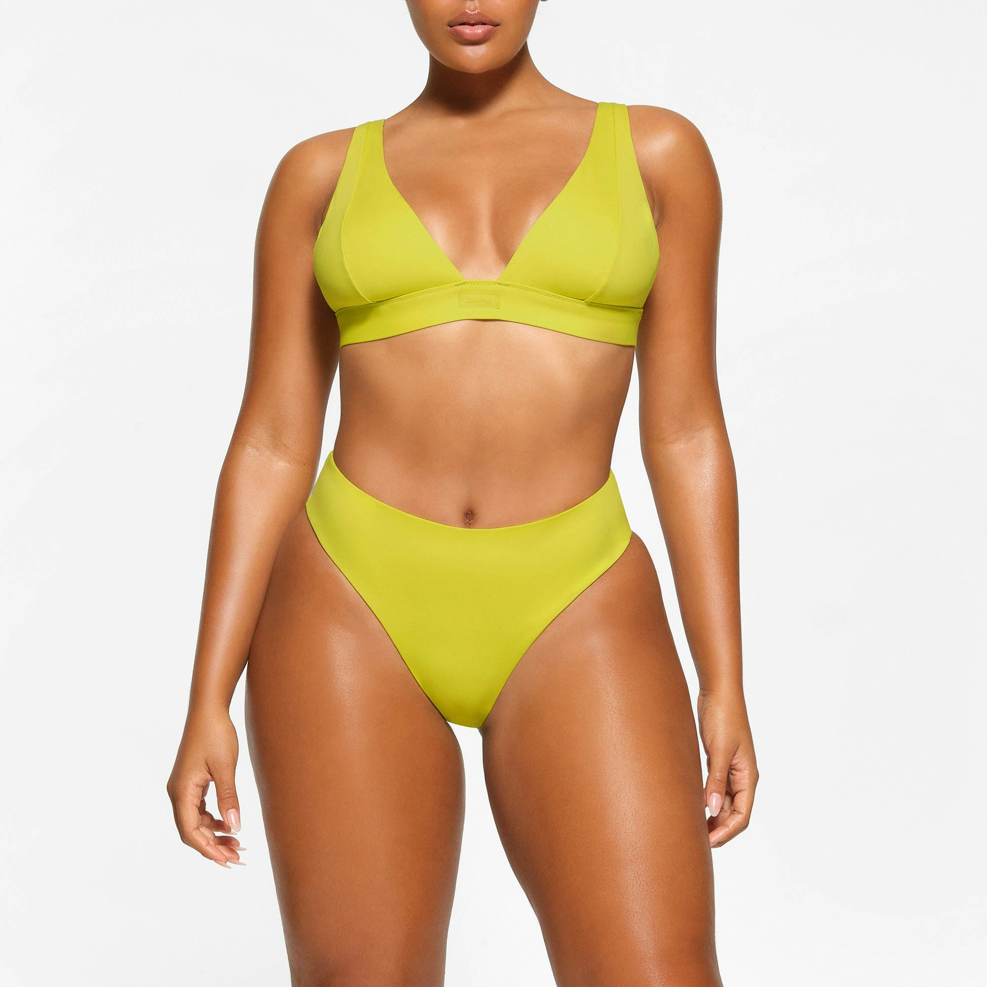 SWIM PLUNGE BIKINI TOP WORN BY A MODEL IN FRONT VIEW