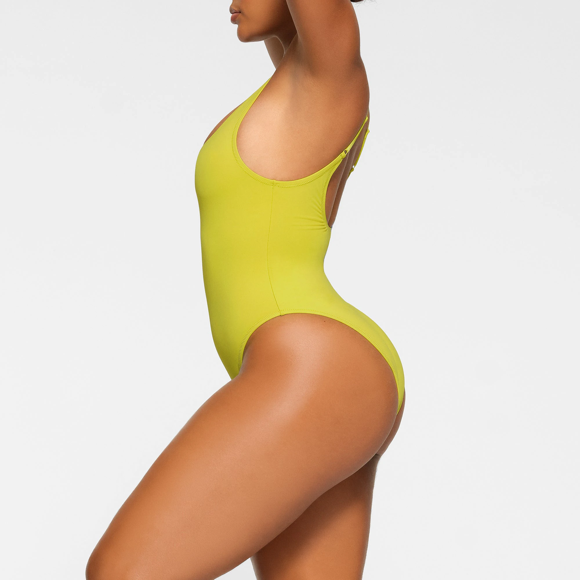 SWIM SCOOP NECK ONE PIECE WORN BY A MODEL IN SIDE VIEW