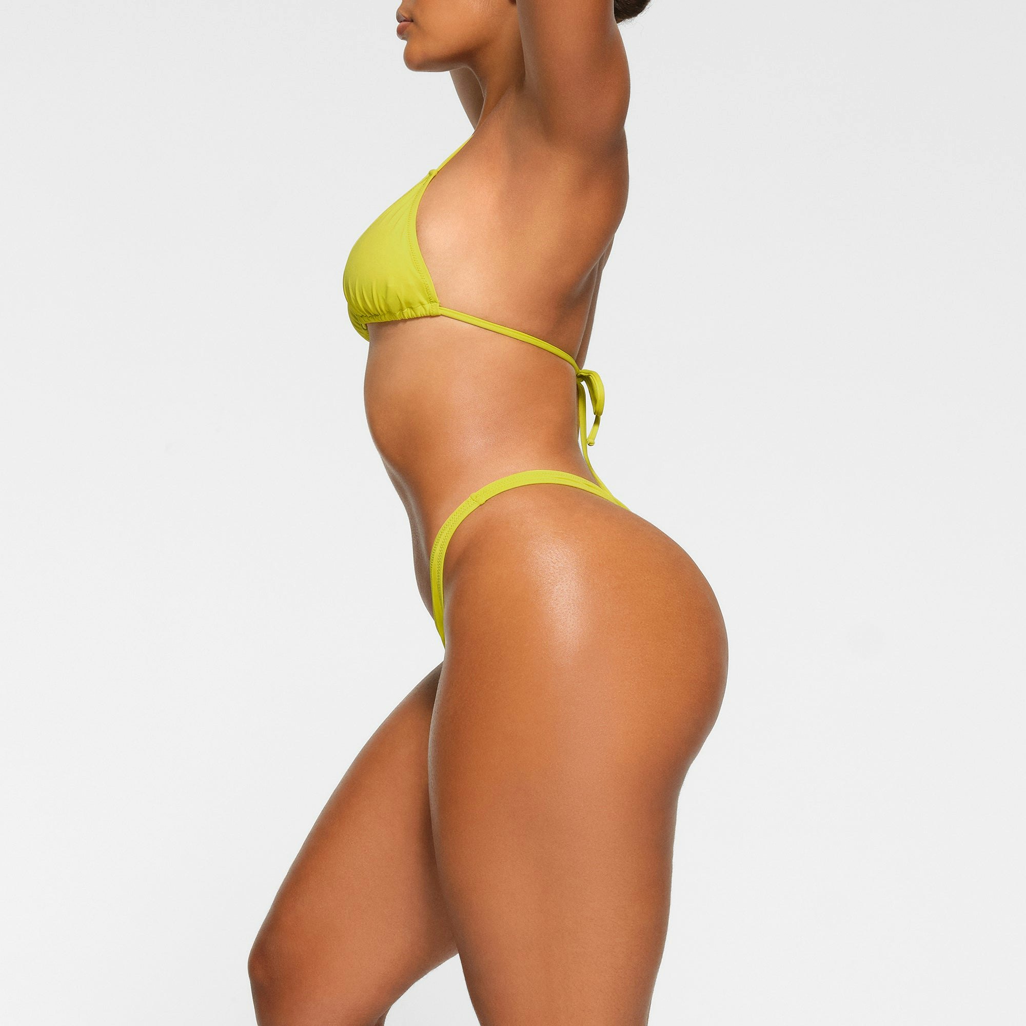 SWIM THONG WORN BY A MODEL IN SIDE VIEW