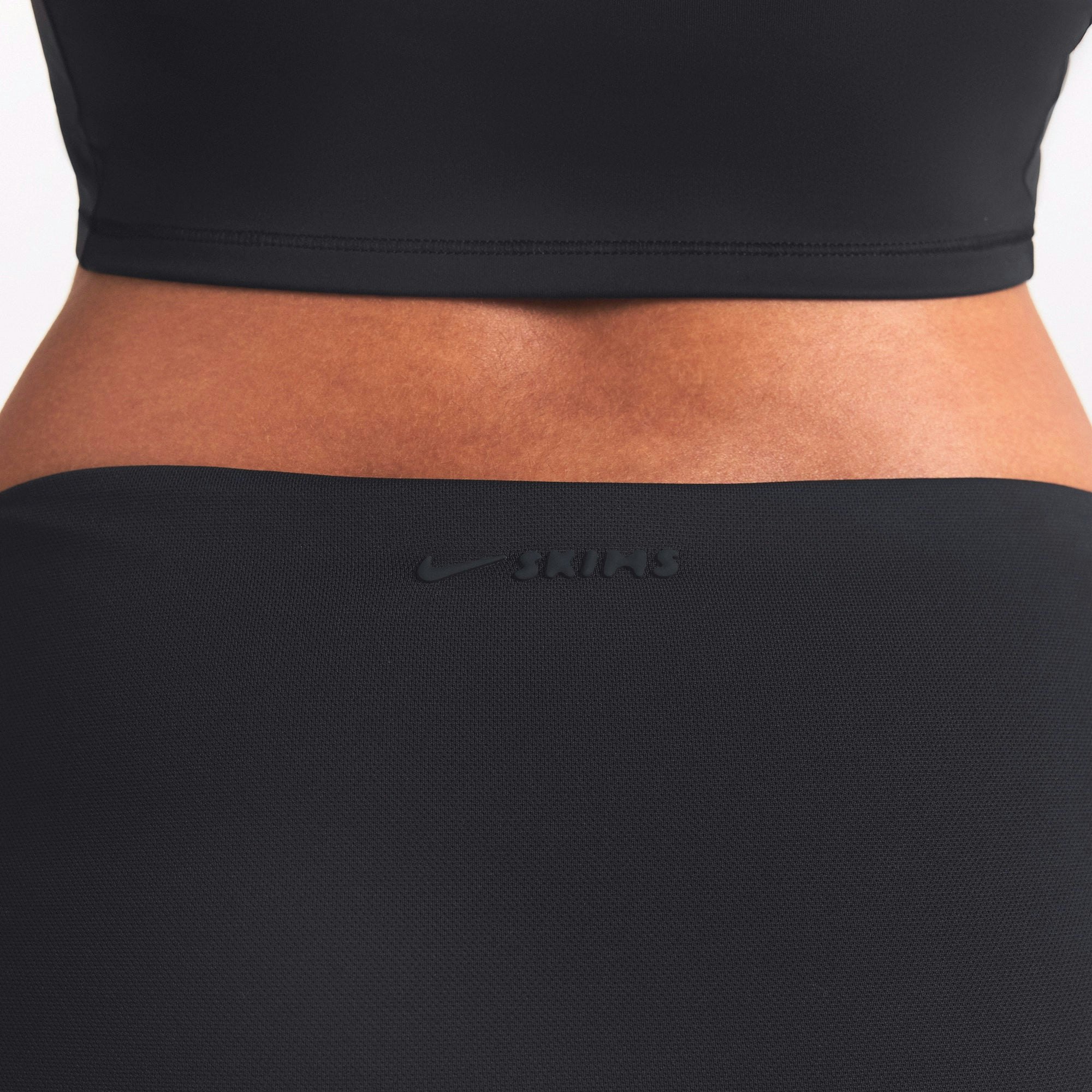 NikeSKIMS AIRY FOLDOVER SKORT | OBSIDIAN ON A MODEL SIDE VIEW @ | FOCUS: 0.0, 1.0, 0.9