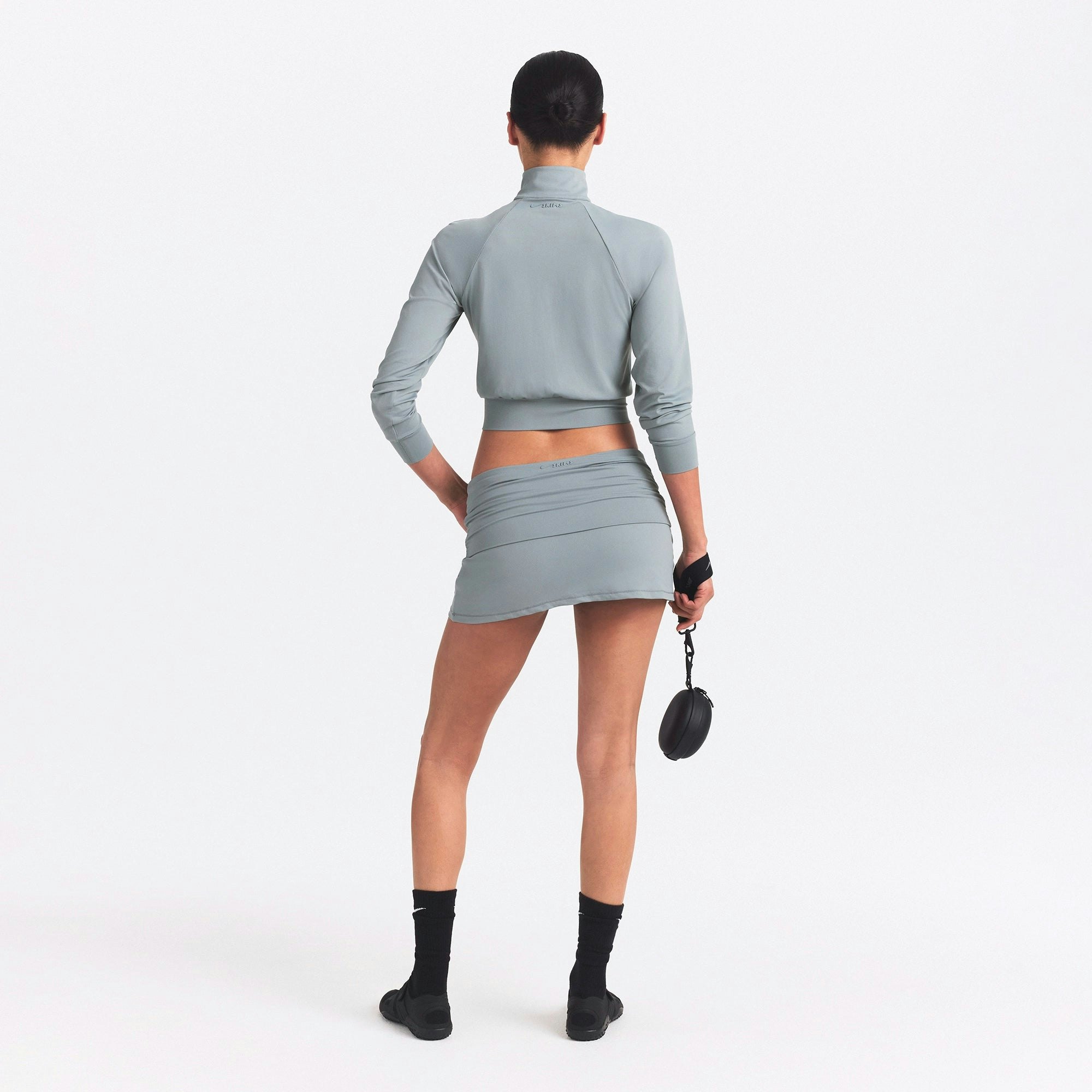 NikeSKIMS AIRY FOLDOVER SKORT | WASHED PACIFIC ON A MODEL SIDE VIEW @ | FOCUS: 0.0, 1.0, 0.9