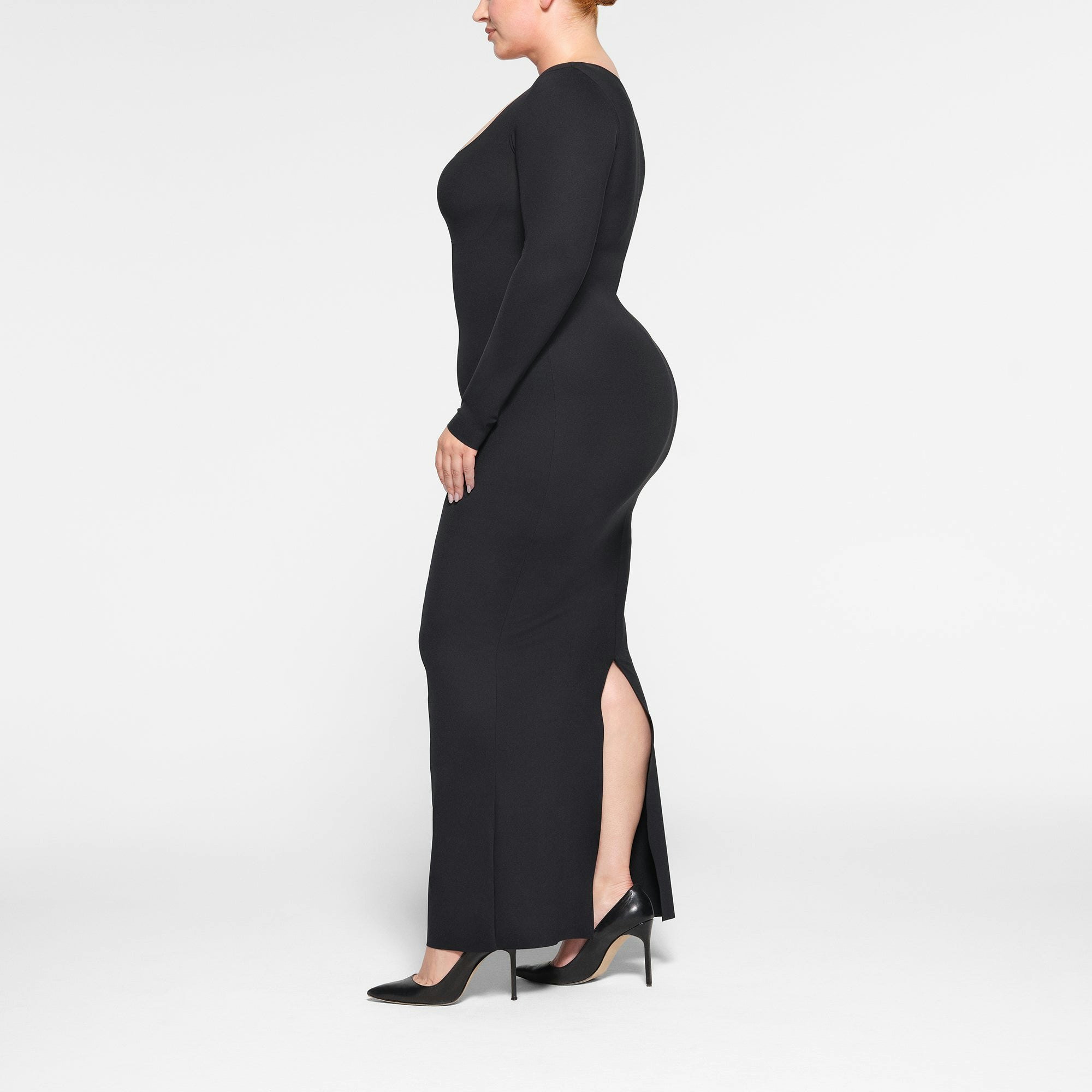 SKIMS BODY LONG SLEEVE LONG DRESS WORN BY A MODEL IN SIDE VIEW