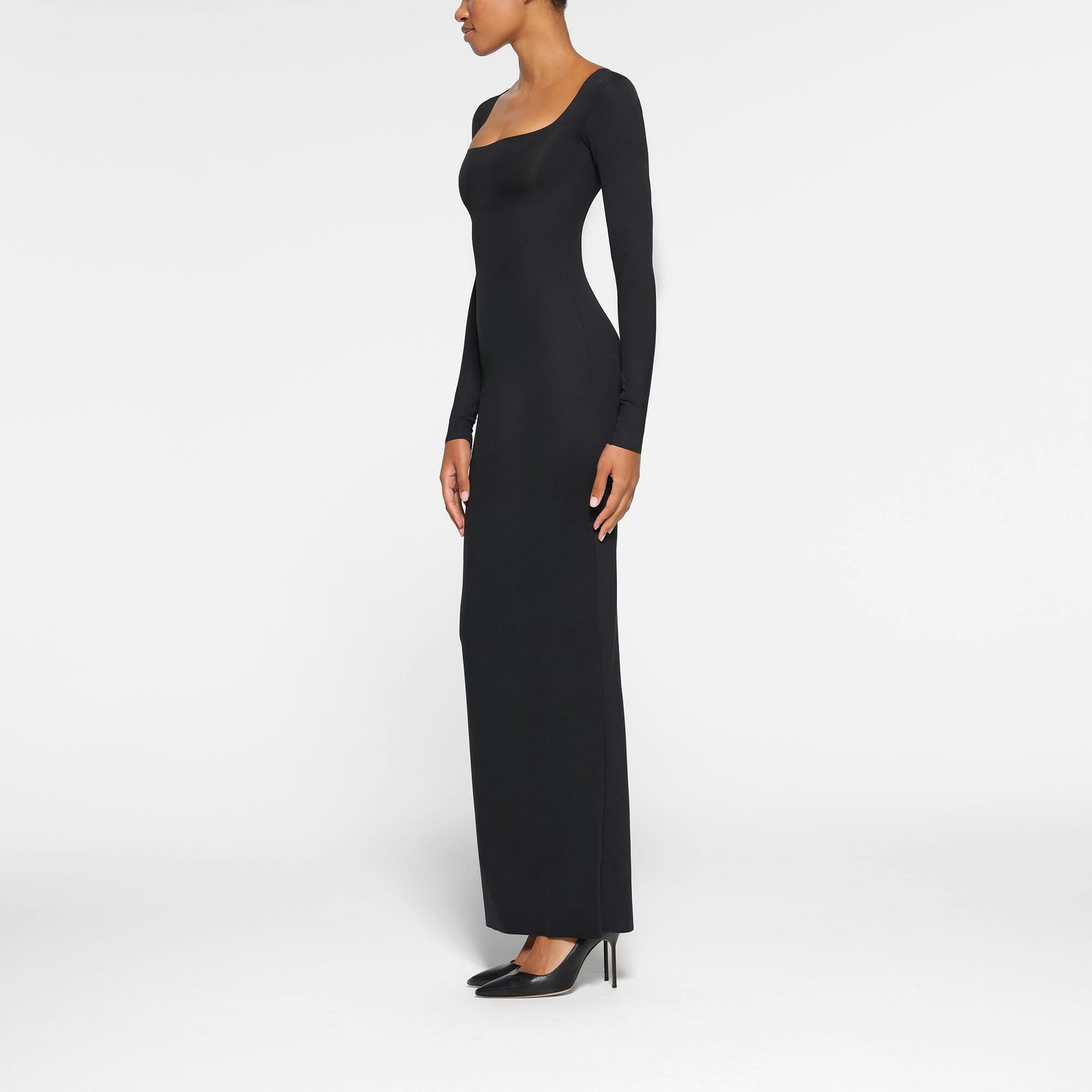 SKIMS BODY LONG SLEEVE LONG DRESS WORN BY A MODEL IN SIDE VIEW