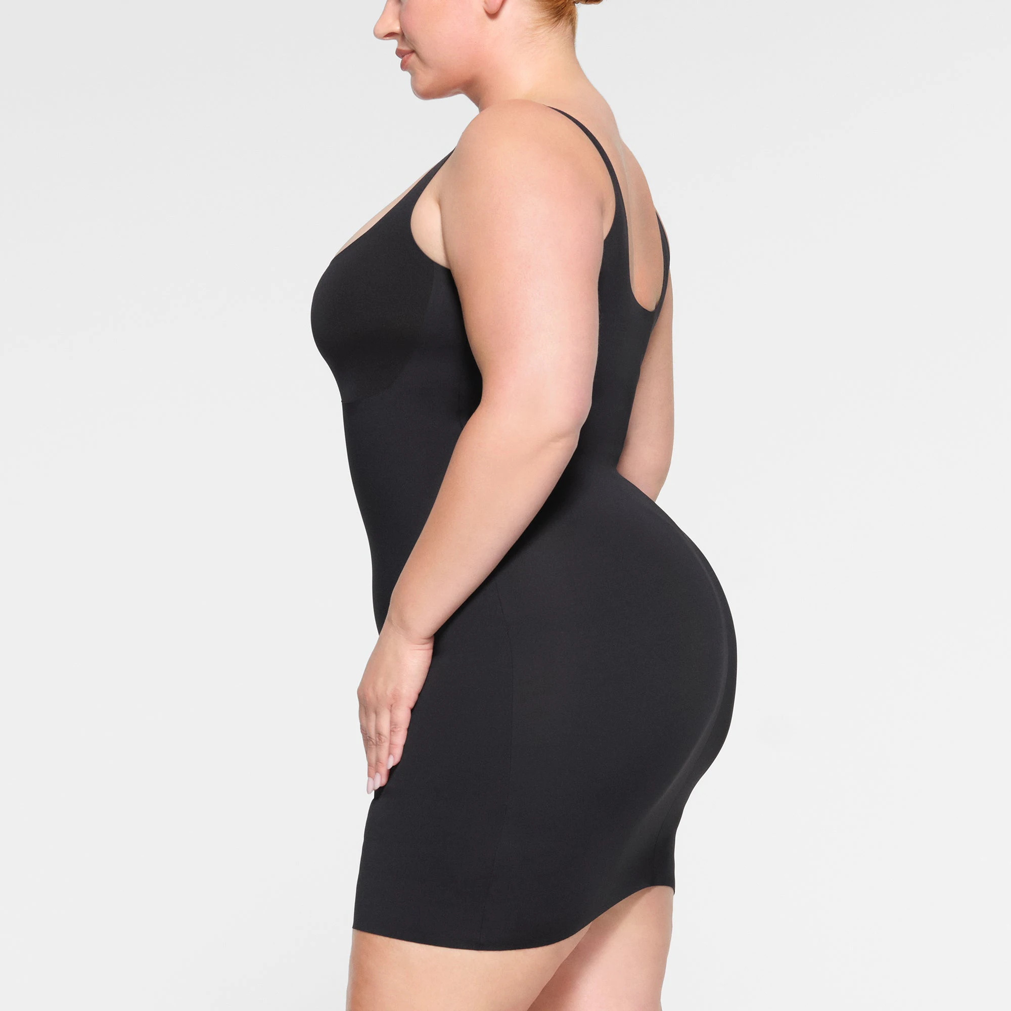 SKIMS BODY TANK MINI DRESS WORN BY A MODEL IN SIDE VIEW