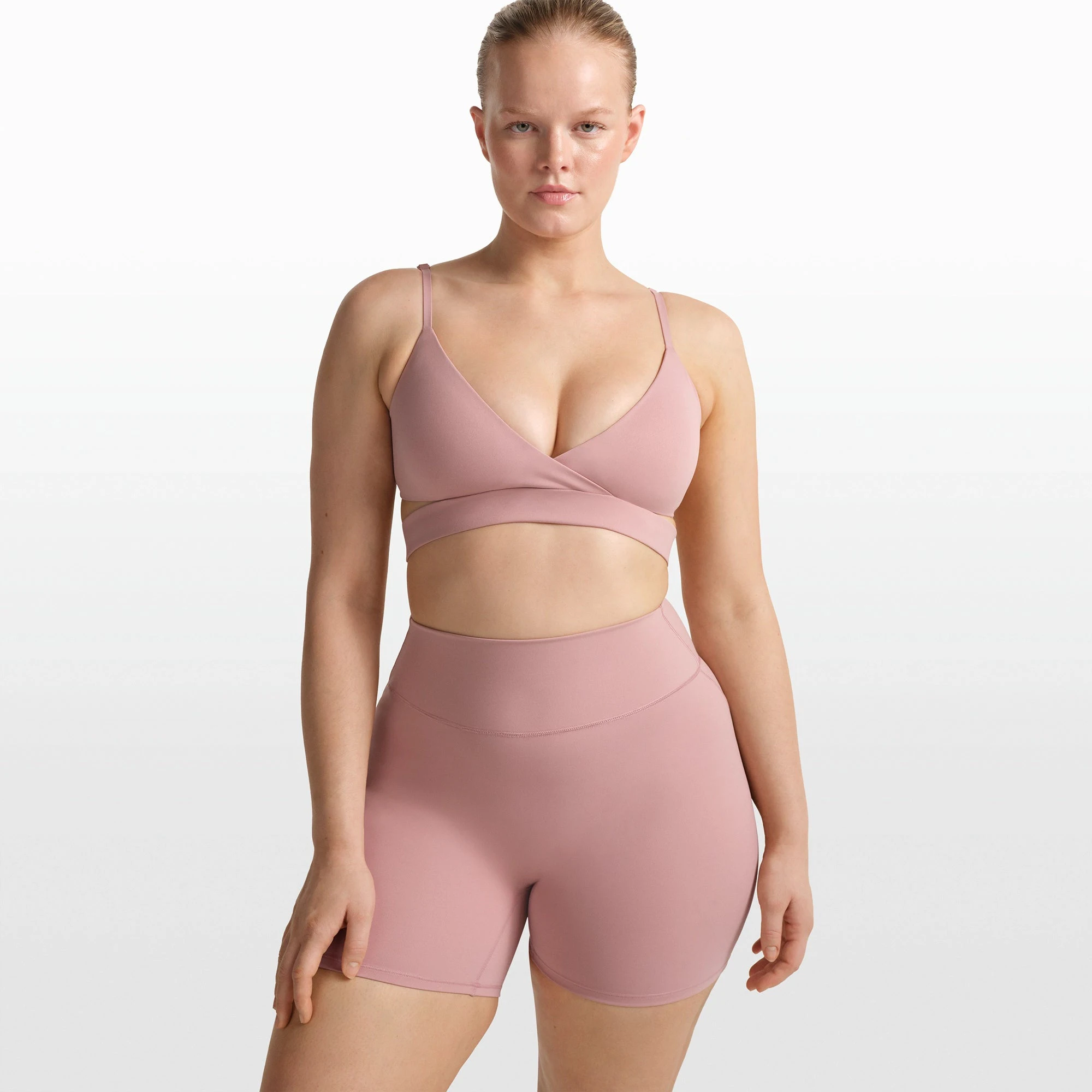 NikeSKIMS MATTE WRAP FRONT BRA | HIMALAYAN ON A MODEL FRONT VIEW @ | FOCUS: 0.0, 1.0, 0.9