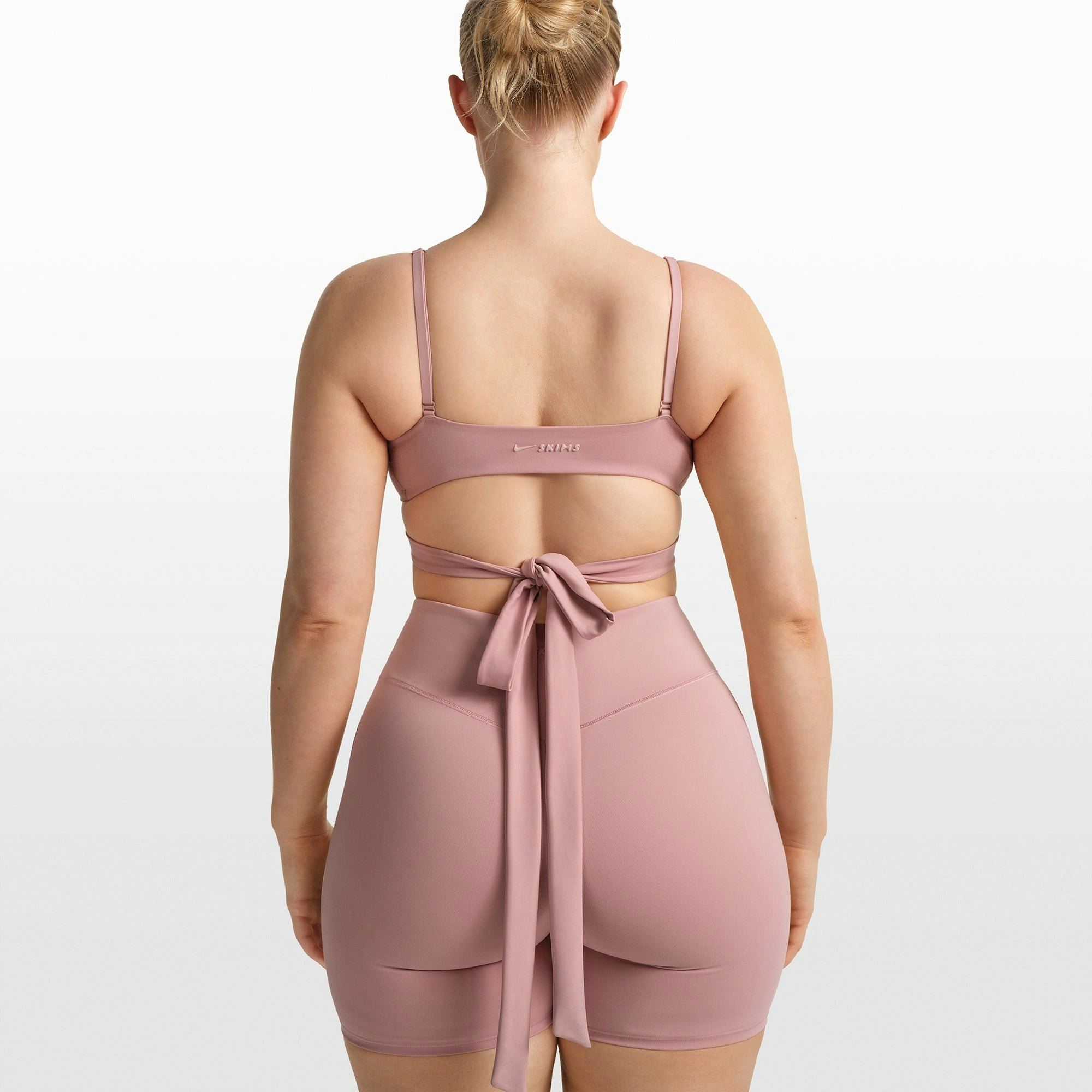 NikeSKIMS MATTE WRAP FRONT BRA | HIMALAYAN ON A MODEL FRONT VIEW @ | FOCUS: 0.0, 1.0, 0.9