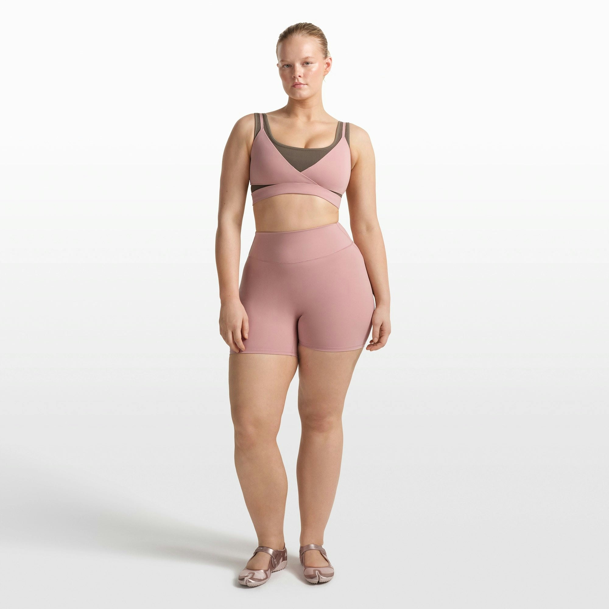 NikeSKIMS MATTE WRAP FRONT BRA | HIMALAYAN ON A MODEL FRONT VIEW @ | FOCUS: 0.0, 1.0, 0.9