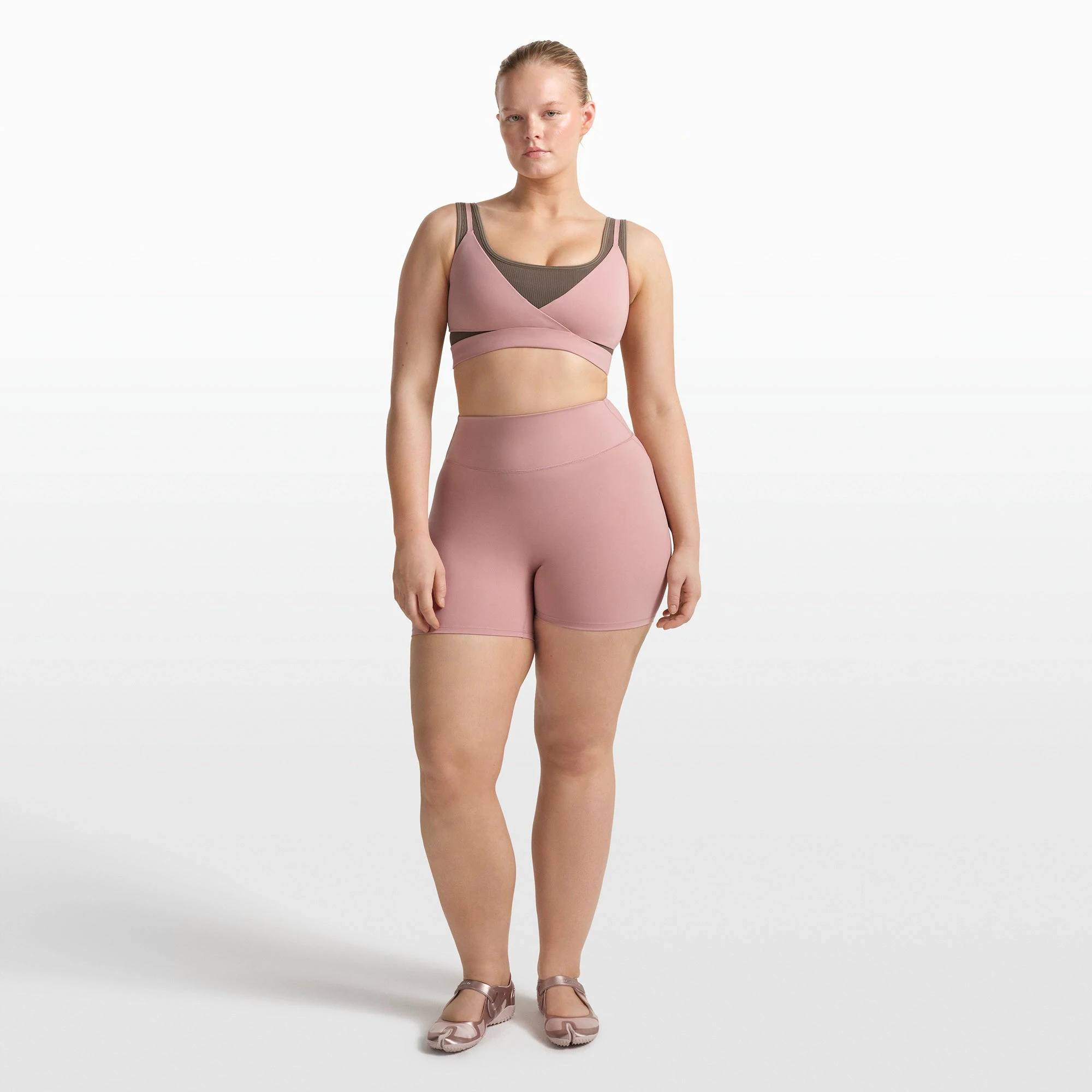 NikeSKIMS MATTE WRAP FRONT BRA | HIMALAYAN ON A MODEL FRONT VIEW @ | FOCUS: 0.0, 1.0, 0.9