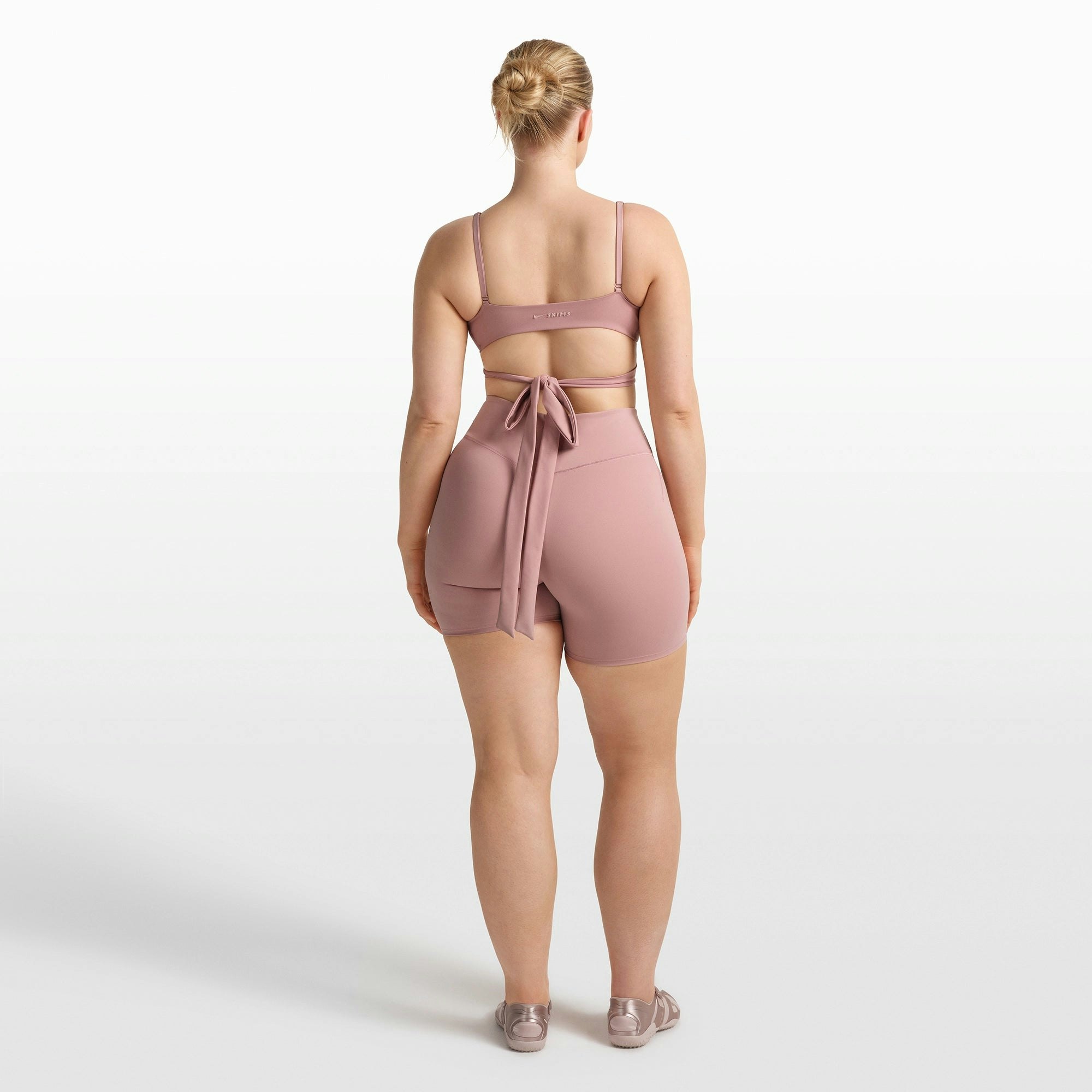 NikeSKIMS MATTE WRAP FRONT BRA | HIMALAYAN ON A MODEL FRONT VIEW @ | FOCUS: 0.0, 1.0, 0.9