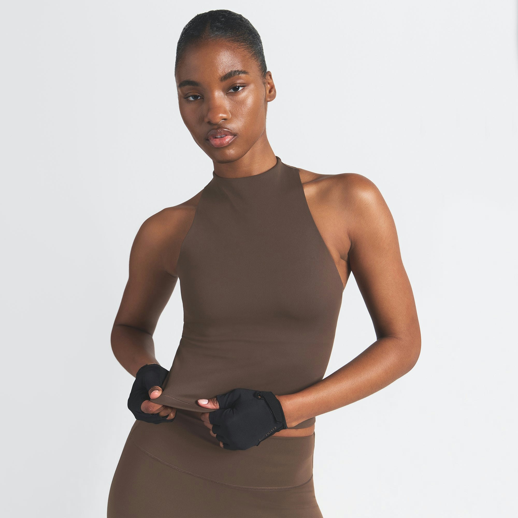 NikeSKIMS MATTE MOCK NECK RACER TANK | DARK SEPIA ON A MODEL FRONT VIEW