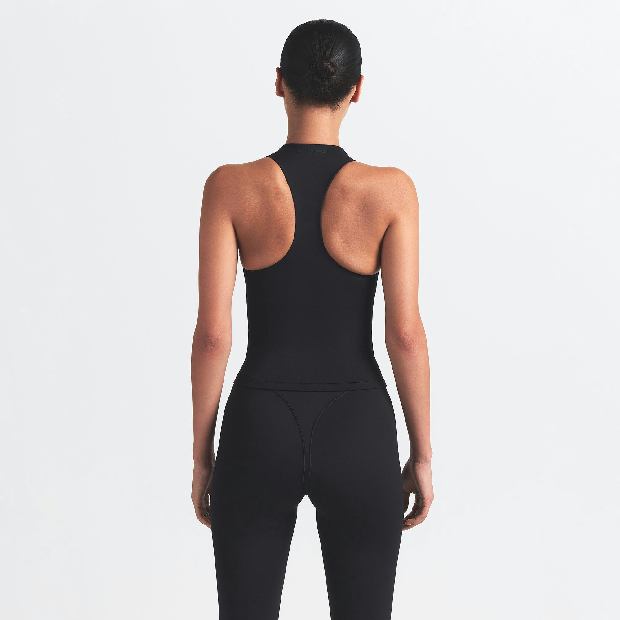 NikeSKIMS MATTE MOCK NECK RACER TANK | OBSIDIAN ON A MODEL BACK VIEW