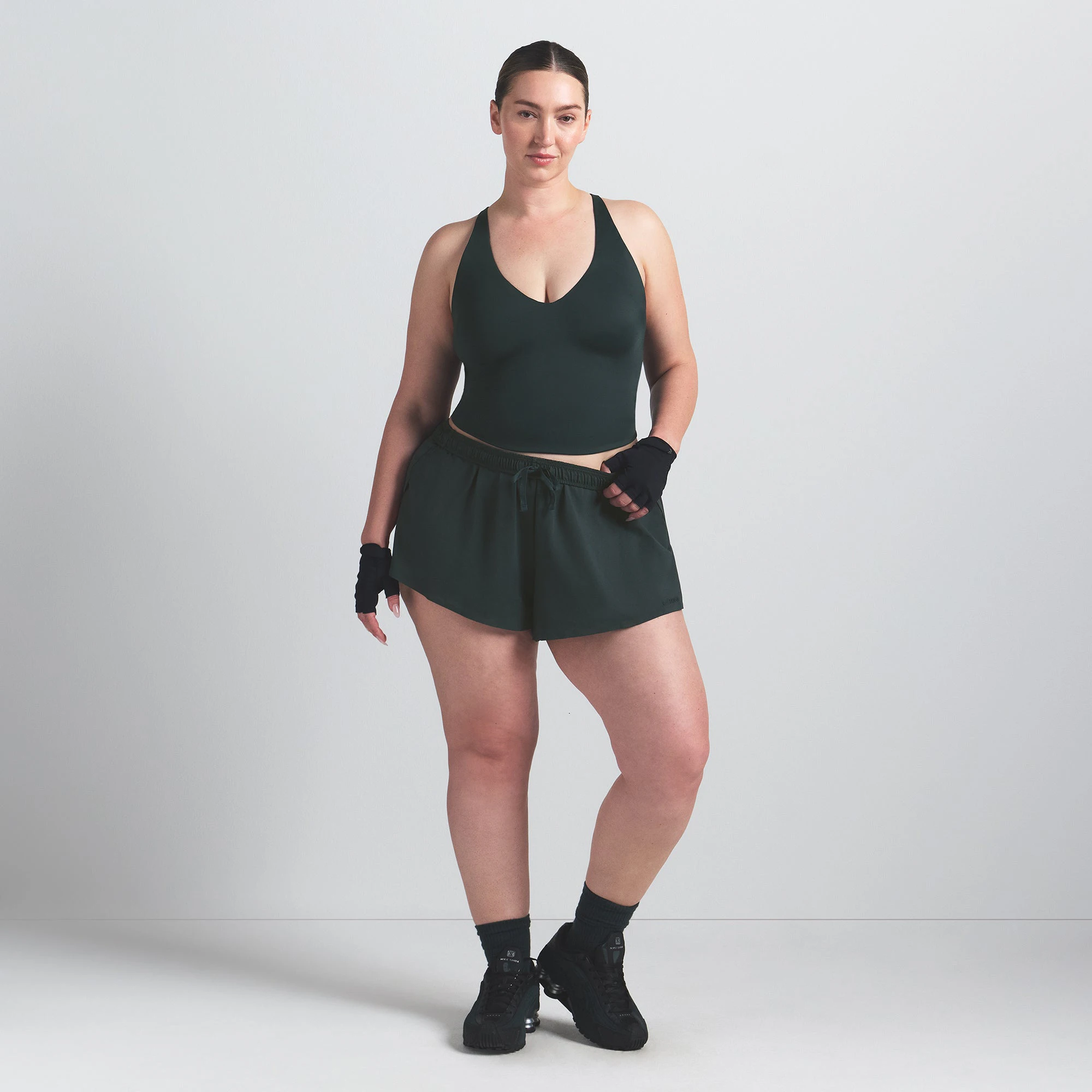 NikeSKIMS SHINE V-NECK TANK | DARK TEAL ON A MODEL FRONT VIEW @ | FOCUS: 0.0, 1.0, 0.9