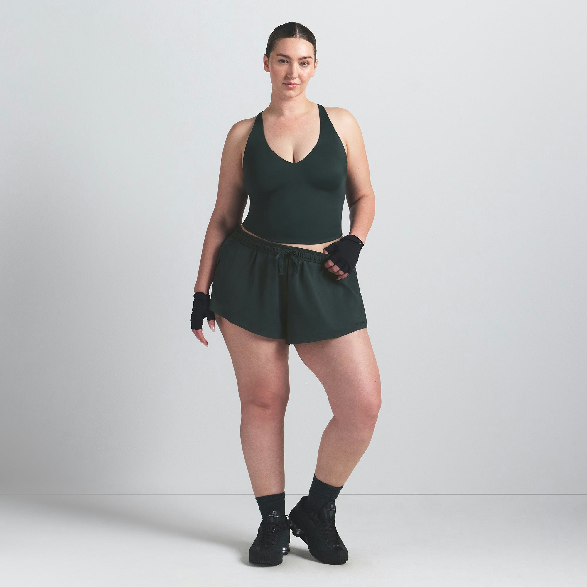 NikeSKIMS SHINE V-NECK TANK | DARK TEAL ON A MODEL FRONT VIEW @ | FOCUS: 0.0, 1.0, 0.9