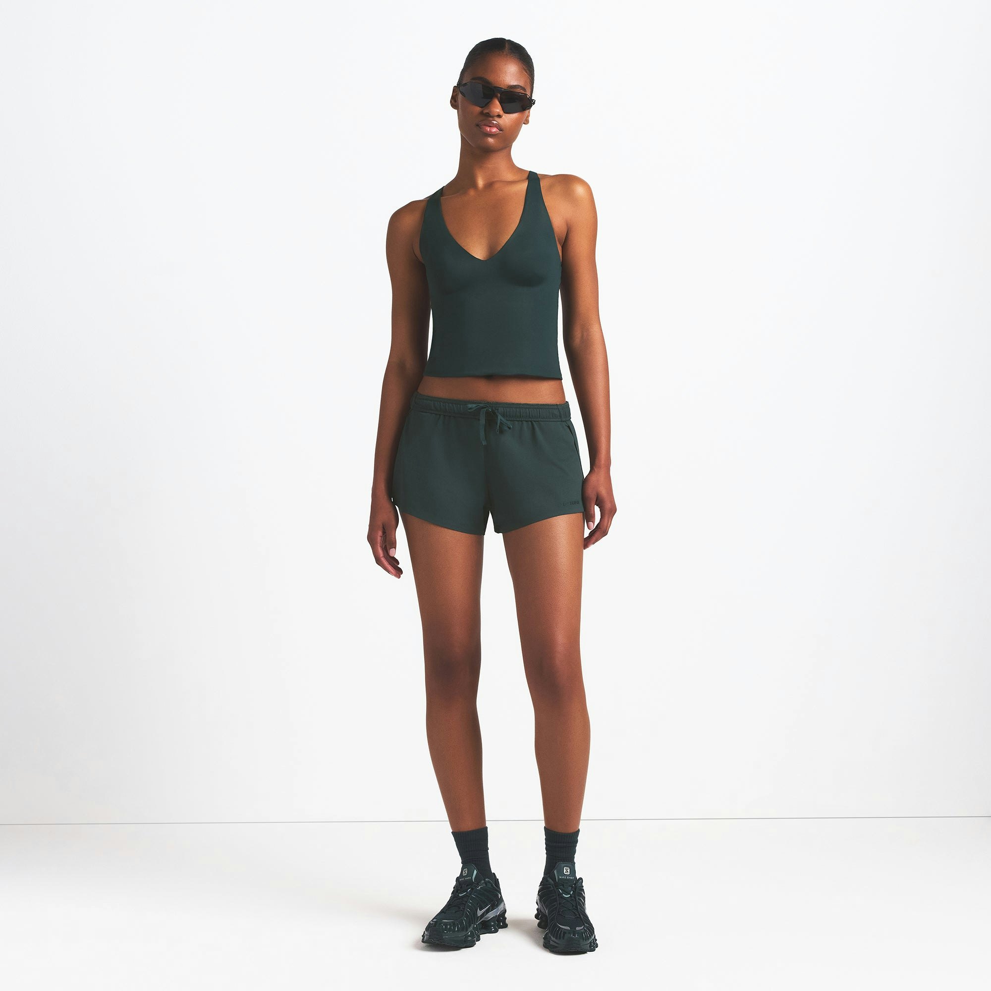 NikeSKIMS SHINE V-NECK TANK | DARK TEAL ON A MODEL FRONT VIEW @ | FOCUS: 0.0, 1.0, 0.9