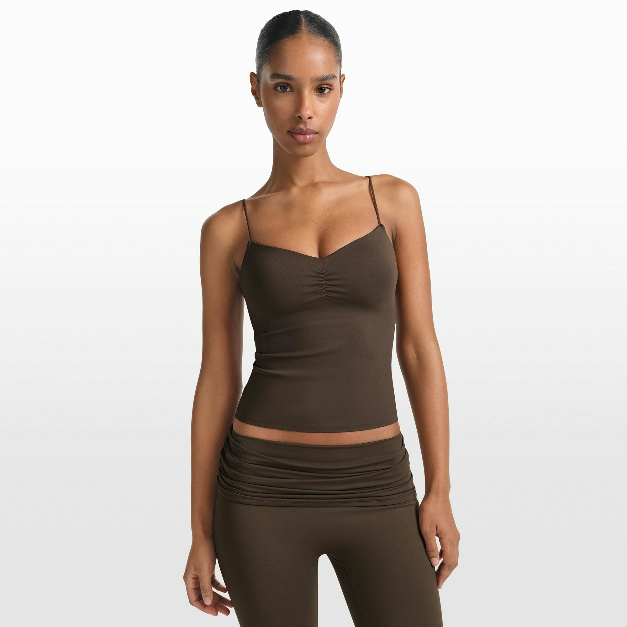 NikeSKIMS MATTE SHIRRED FRONT TANK | DARK SEPIA ON A MODEL FRONT VIEW @ | FOCUS: 0.0, 1.0, 0.9