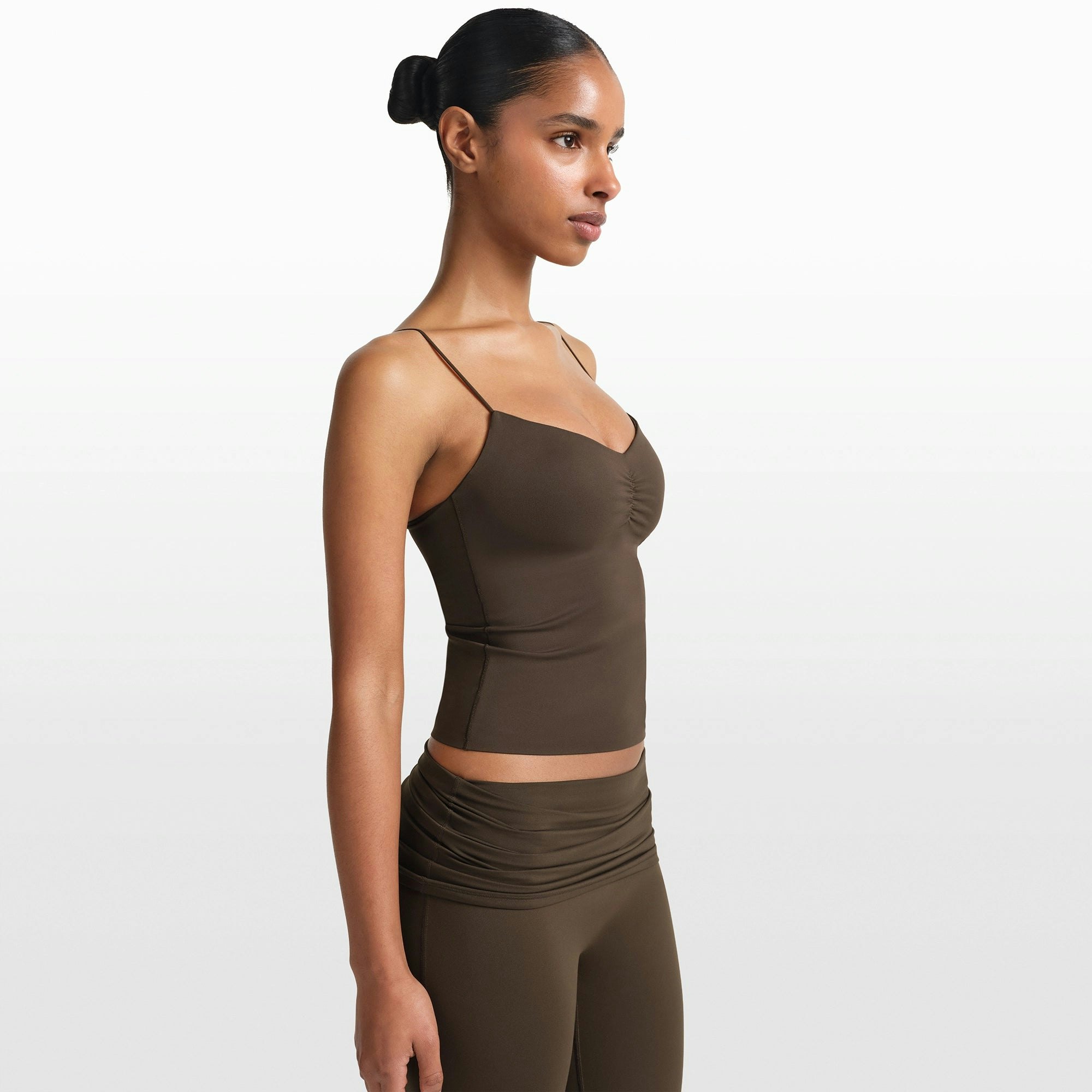 NikeSKIMS MATTE SHIRRED FRONT TANK | DARK SEPIA ON A MODEL FRONT VIEW @ | FOCUS: 0.0, 1.0, 0.9