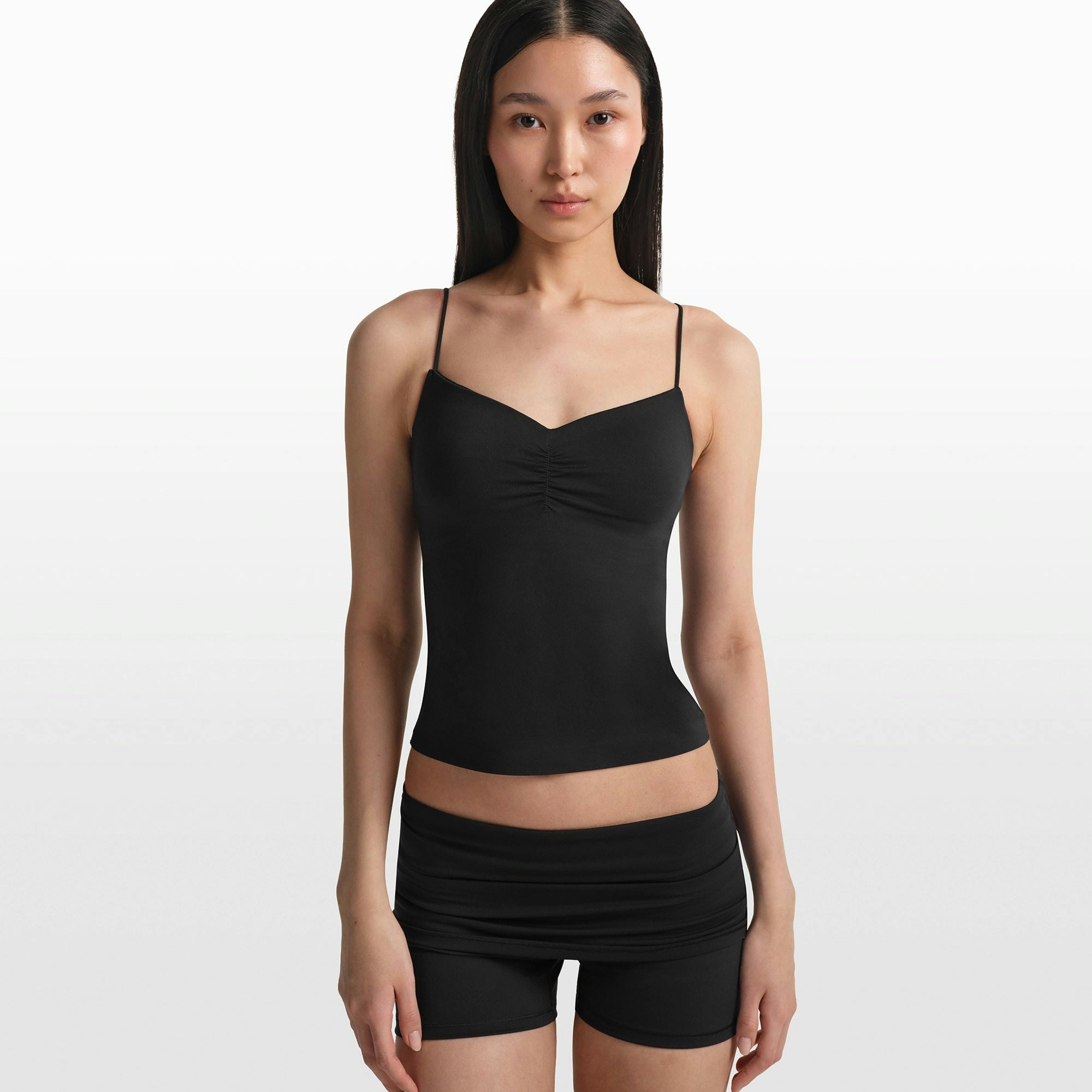 NikeSKIMS MATTE SHIRRED FRONT TANK | OBSIDIAN ON A MODEL FRONT VIEW @ | FOCUS: 0.0, 1.0, 0.9