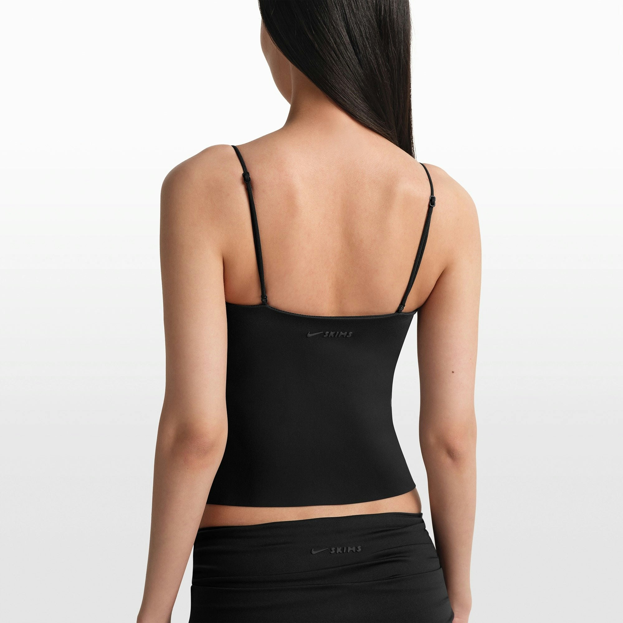 NikeSKIMS MATTE SHIRRED FRONT TANK | OBSIDIAN ON A MODEL FRONT VIEW @ | FOCUS: 0.0, 1.0, 0.9