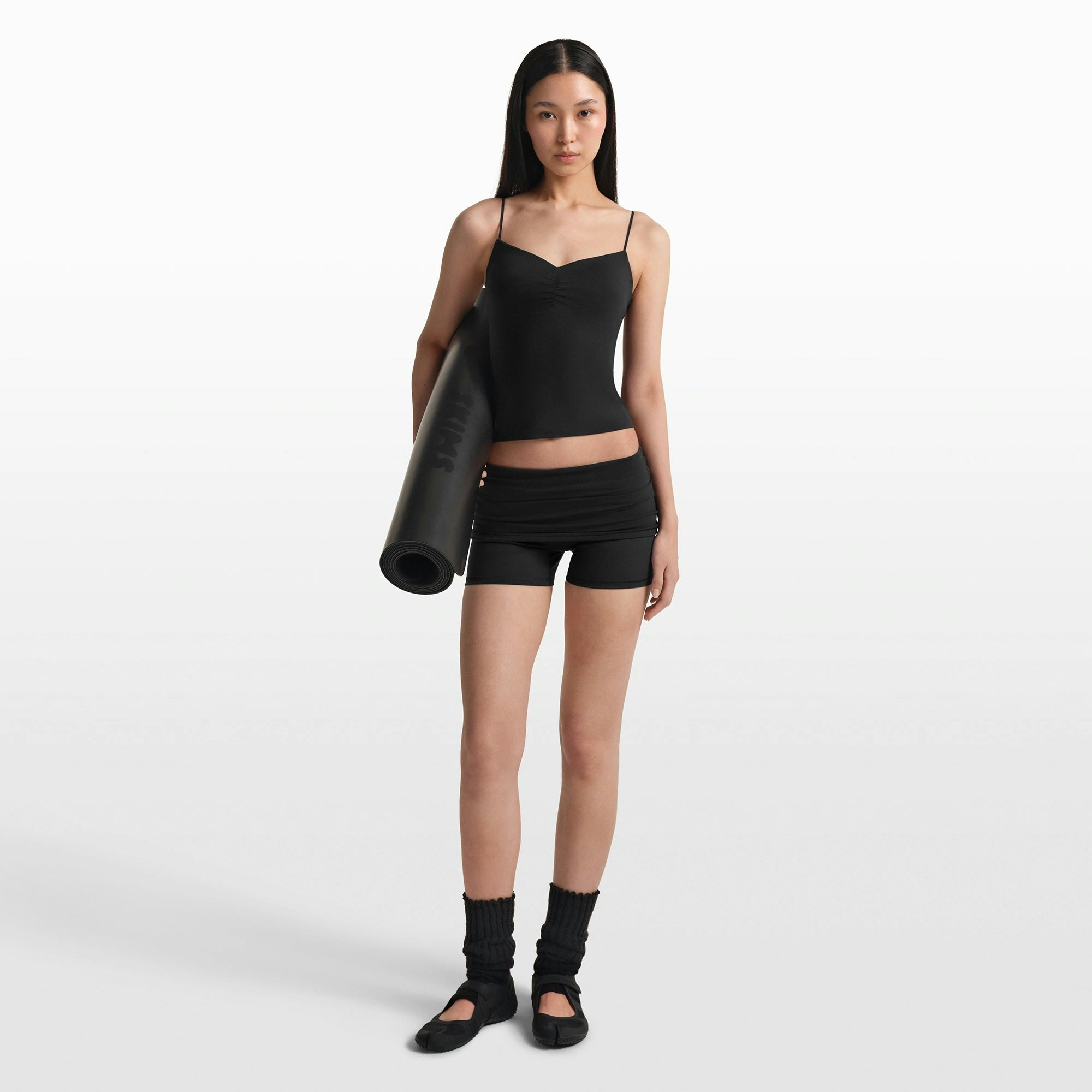 NikeSKIMS MATTE SHIRRED FRONT TANK | OBSIDIAN ON A MODEL FRONT VIEW @ | FOCUS: 0.0, 1.0, 0.9