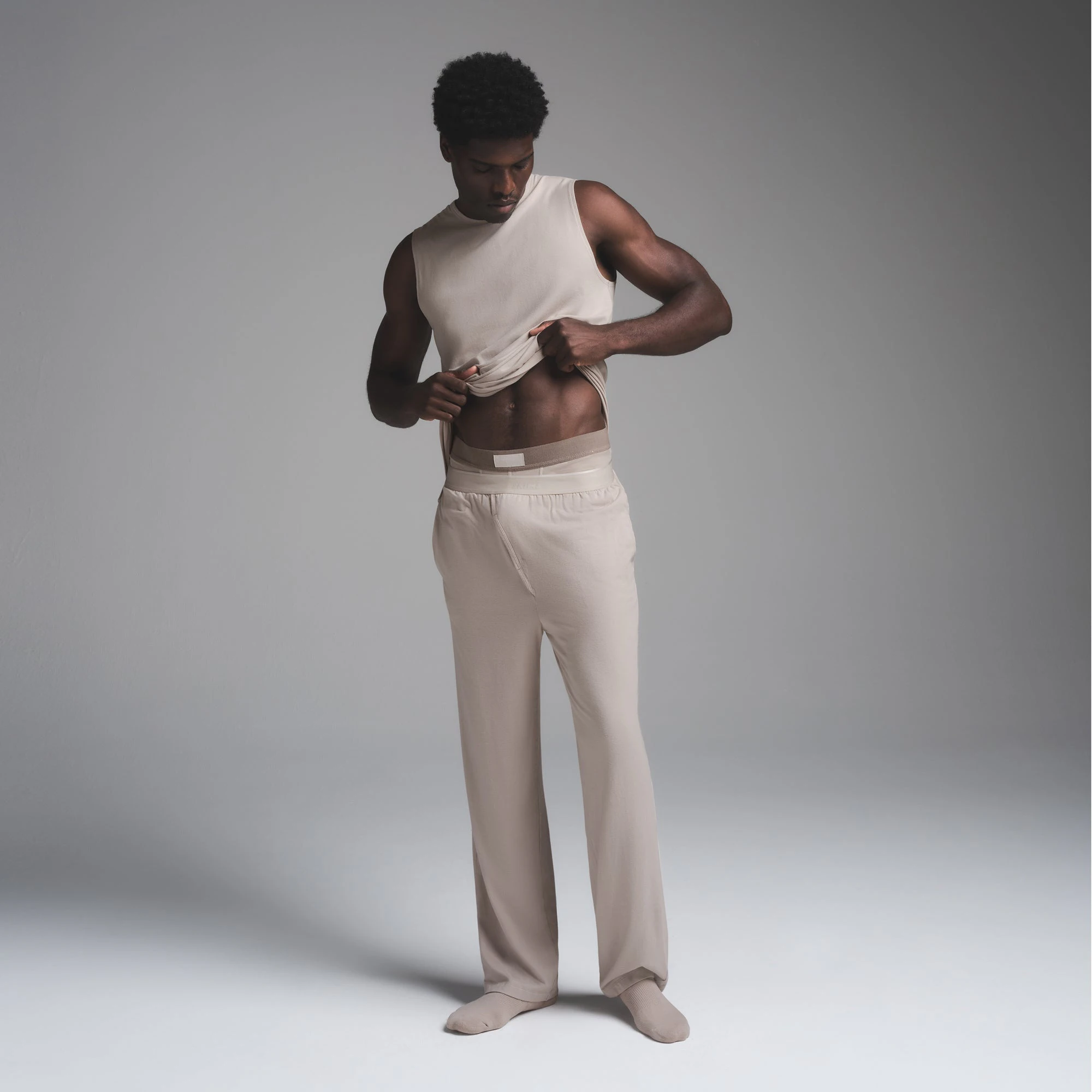 JERSEY SLEEP MENS TANK | STONE ON A MODEL FRONT VIEW