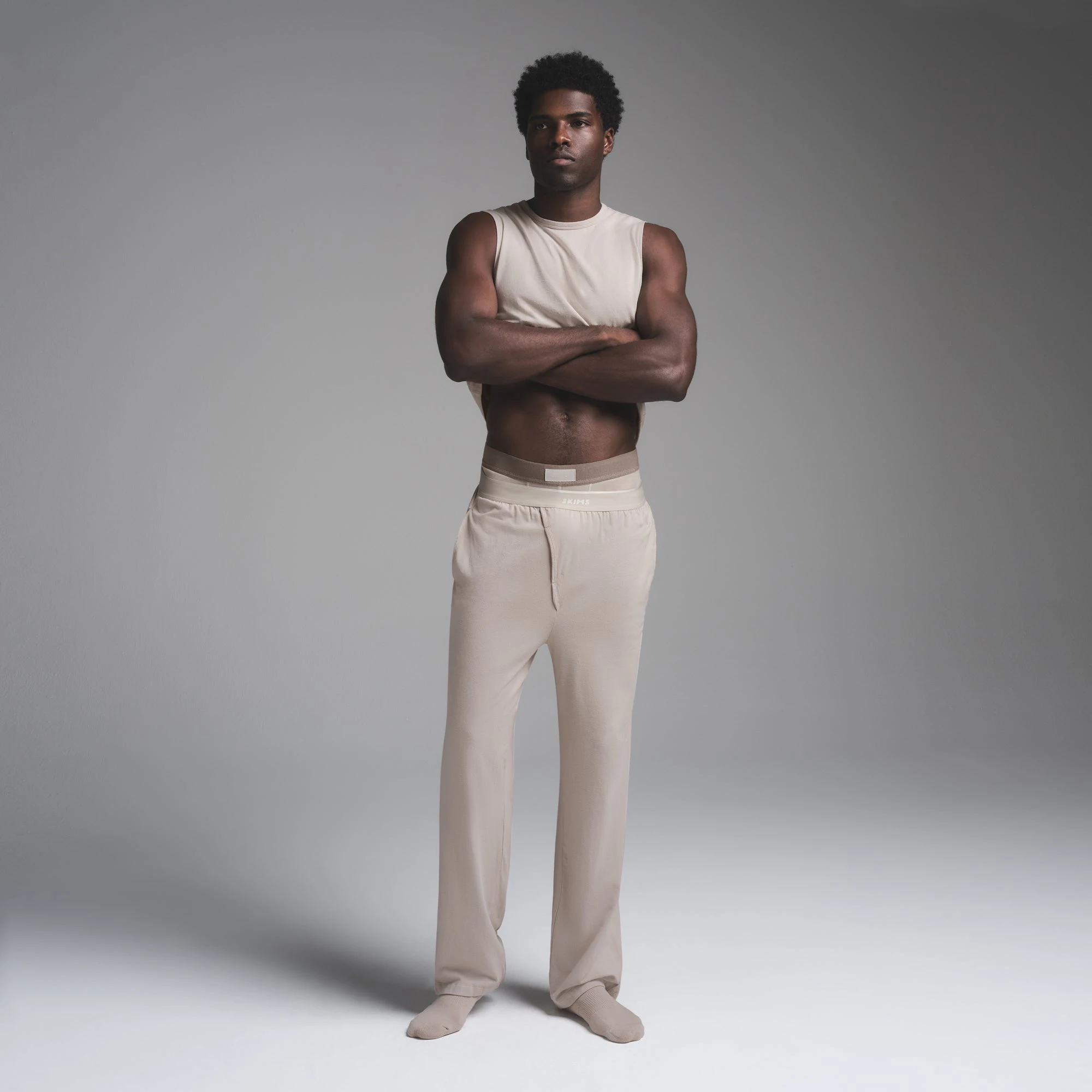 JERSEY SLEEP MENS TANK | STONE ON A MODEL FRONT VIEW