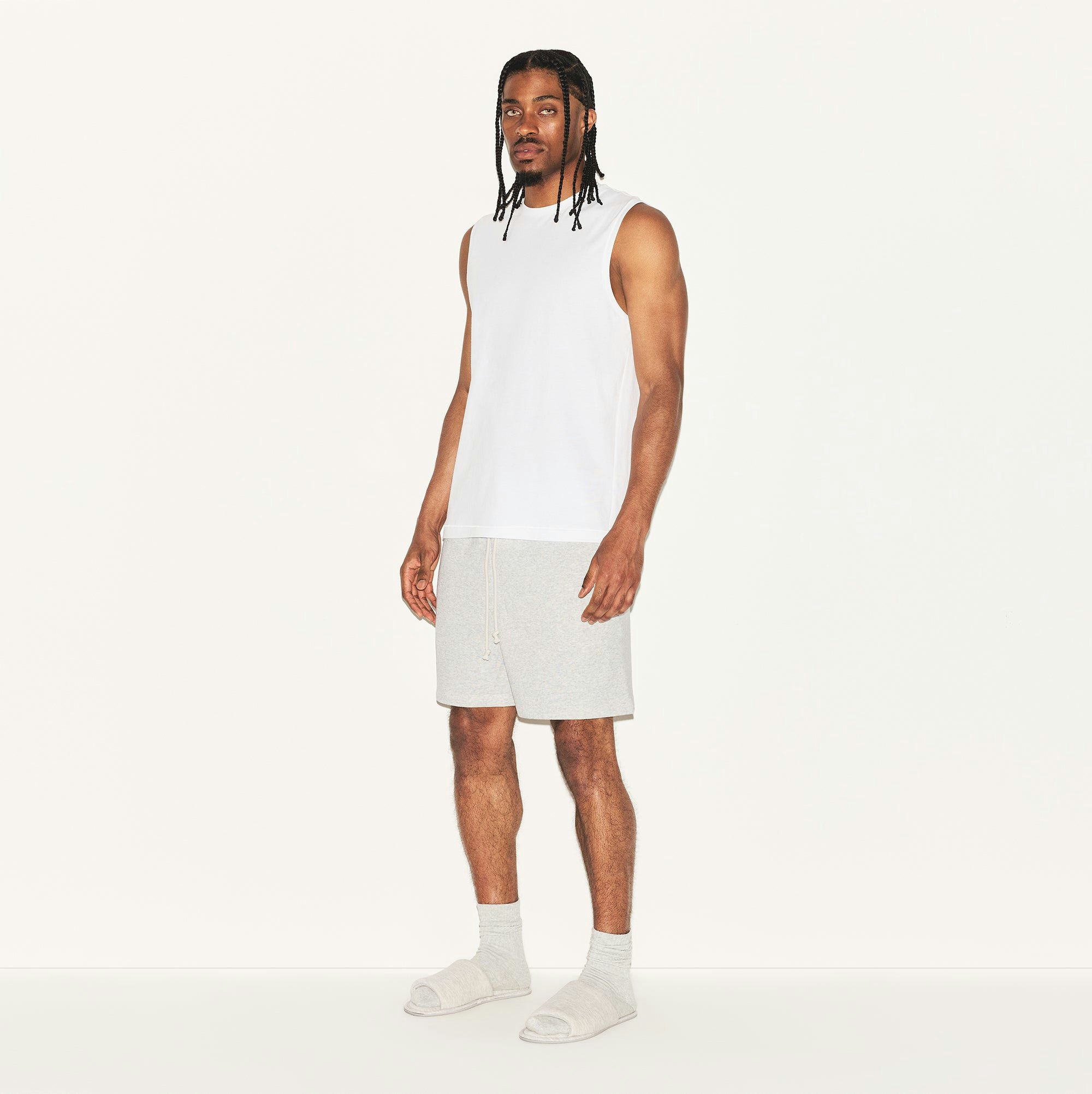 SKIMS COTTON MENS RELAXED SLEEVELESS SHIRT | CHALK ON A MODEL SIDE VIEW | FOCUS: 0.0, 1.0, 0.9