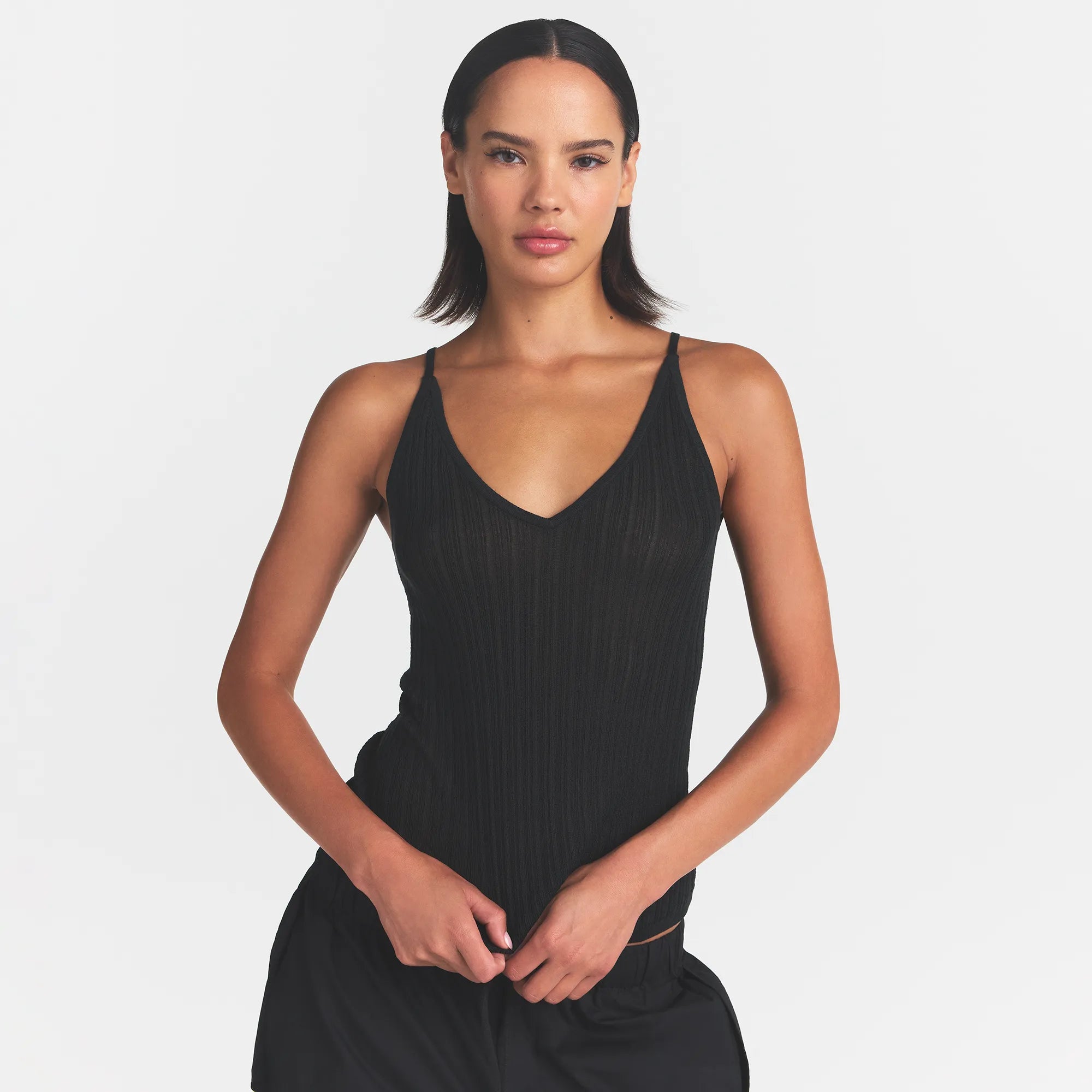 SHEER KNIT PLUNGE TANK | ONYX ON A MODEL FRONT VIEW @ | FOCUS: 0.0, 1.0, 0.9