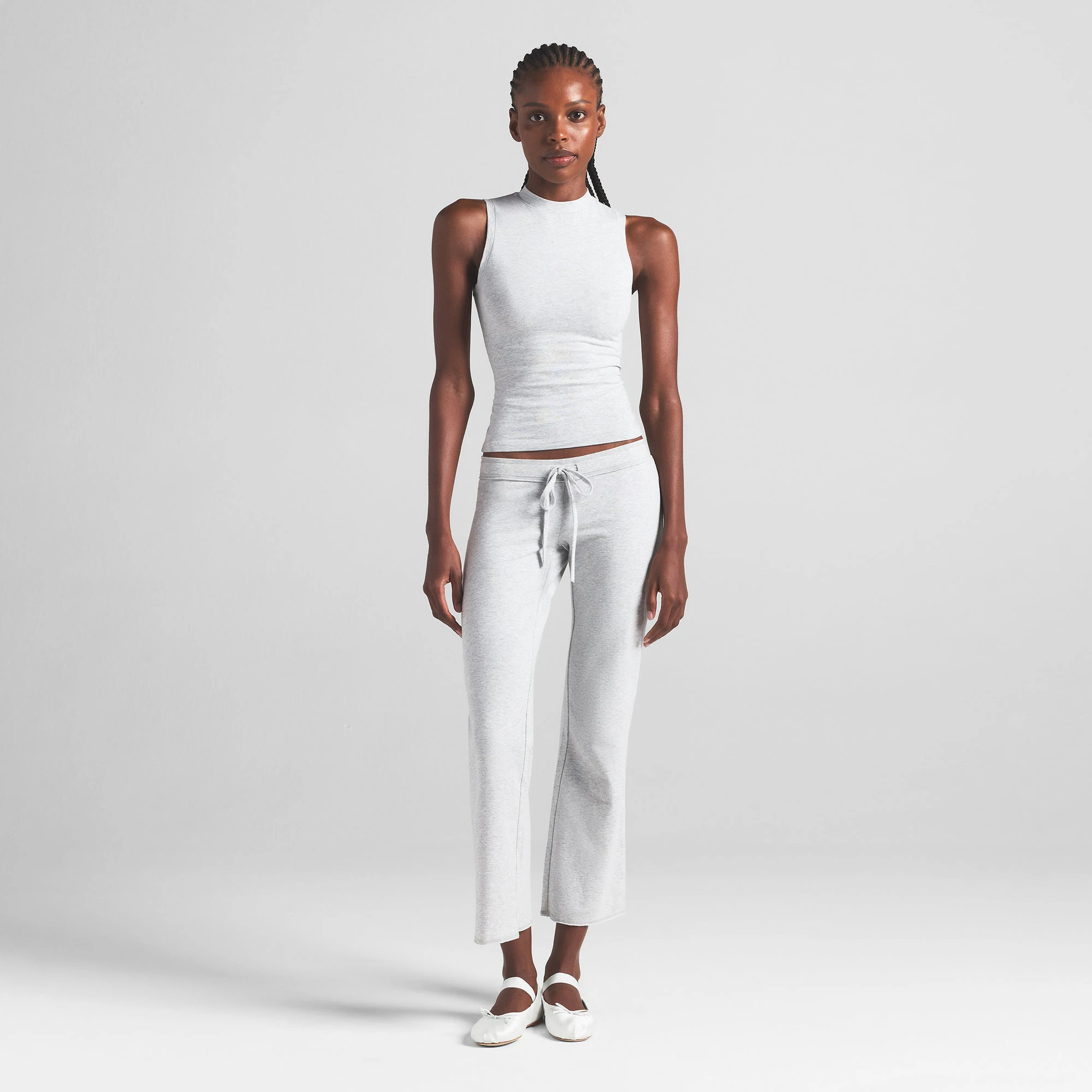 COTTON JERSEY MOCK NECK TANK | LIGHT HEATHER GREY ON A MODEL FRONT VIEW | FOCUS: 0.0, 1.0, 0.9