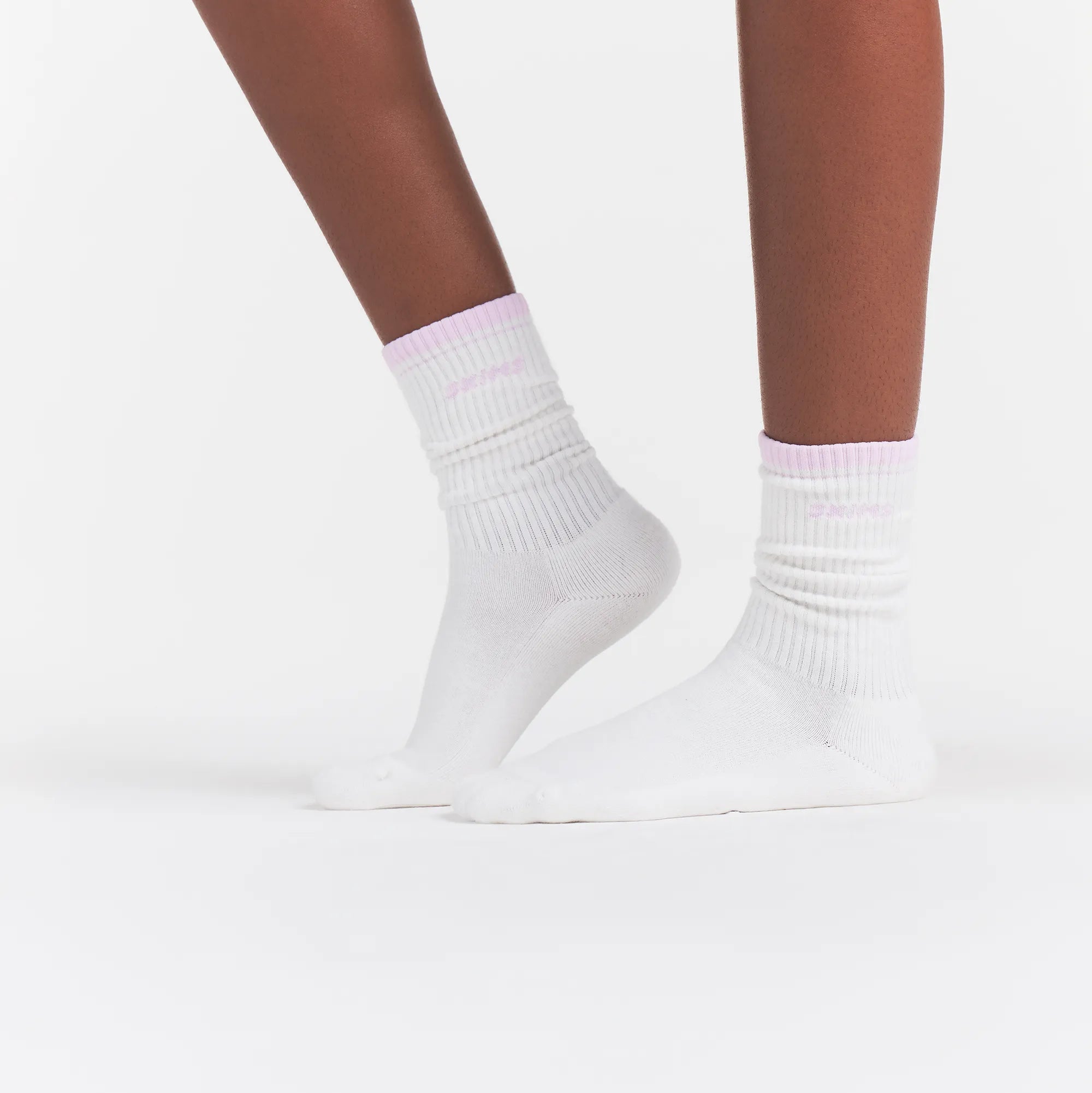 RIBBED CREW LOGO SOCK | SNOW AND CHERRY BLOSSOM ON A MODEL | FOCUS: 0.0, 1.0, 0.9