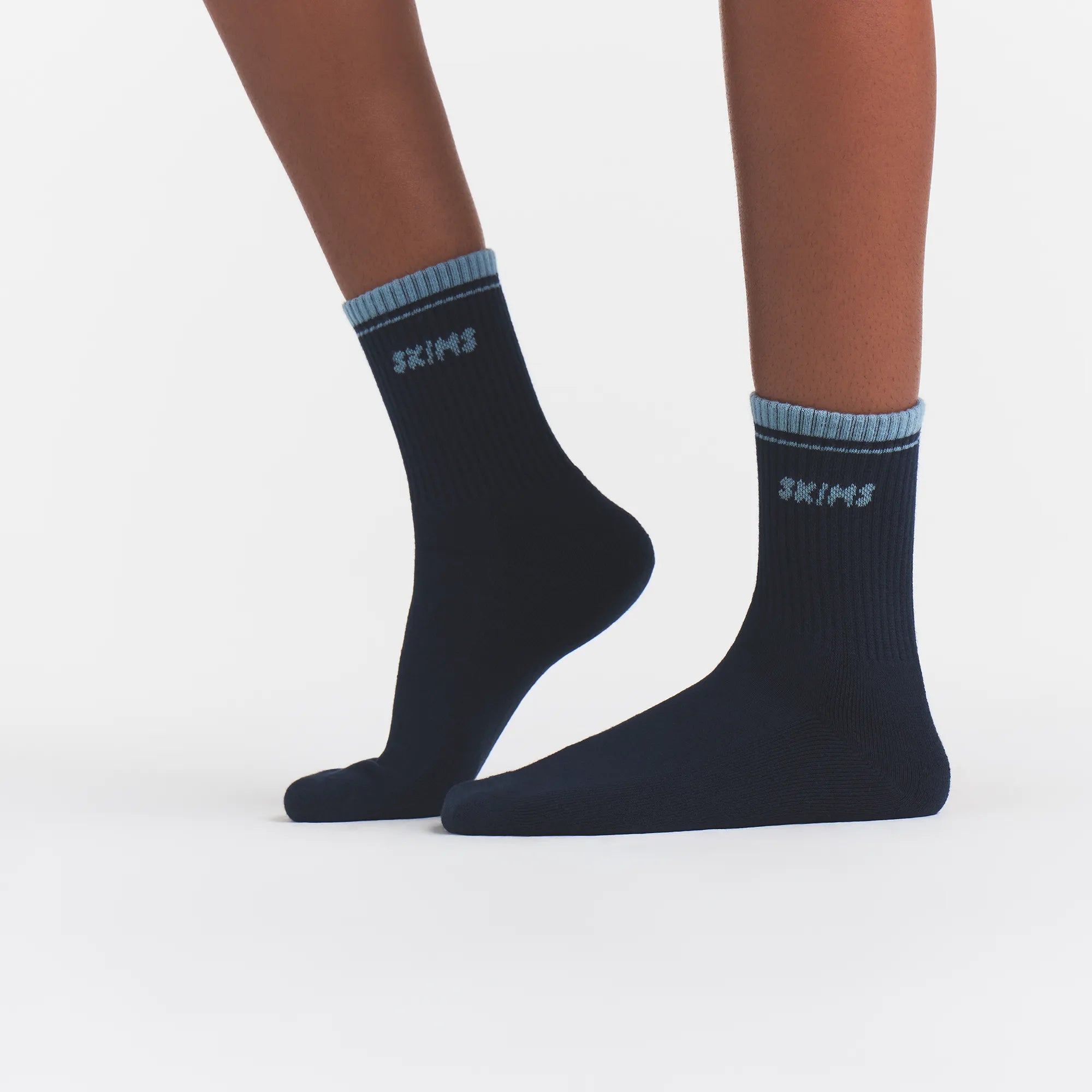 RIBBED QUARTER CREW LOGO SOCK | NAVY AND KYANITE ON A MODEL | FOCUS: 0.0, 1.0, 0.9