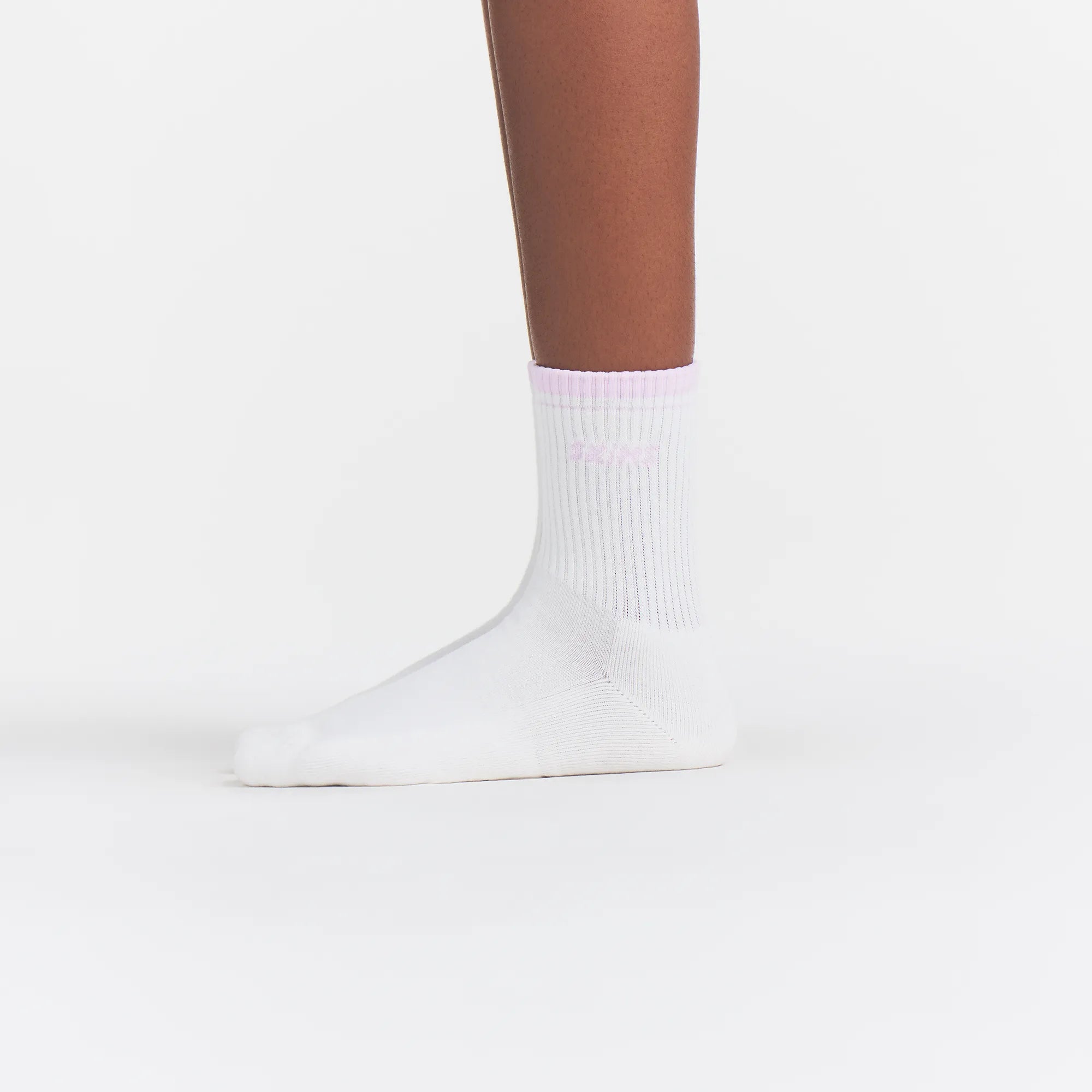 RIBBED QUARTER CREW LOGO SOCK | SNOW AND CHERRY BLOSSOM ON A MODEL | FOCUS: 0.0, 1.0, 0.9
