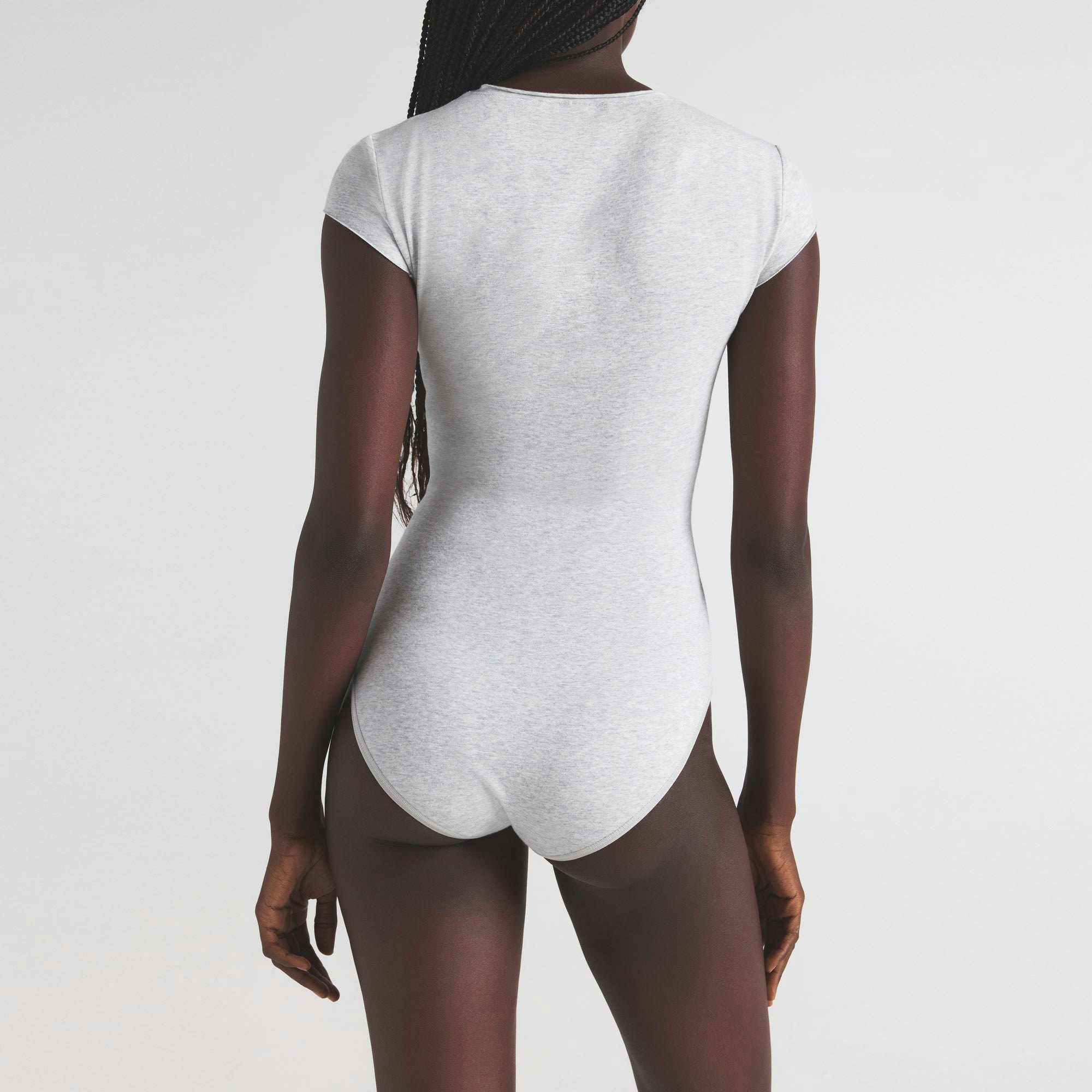 COTTON JERSEY T-SHIRT BRIEF BODYSUIT | LIGHT HEATHER GREY ON A MODEL SIDE VIEW | FOCUS: 0.0, 1.0, 0.9