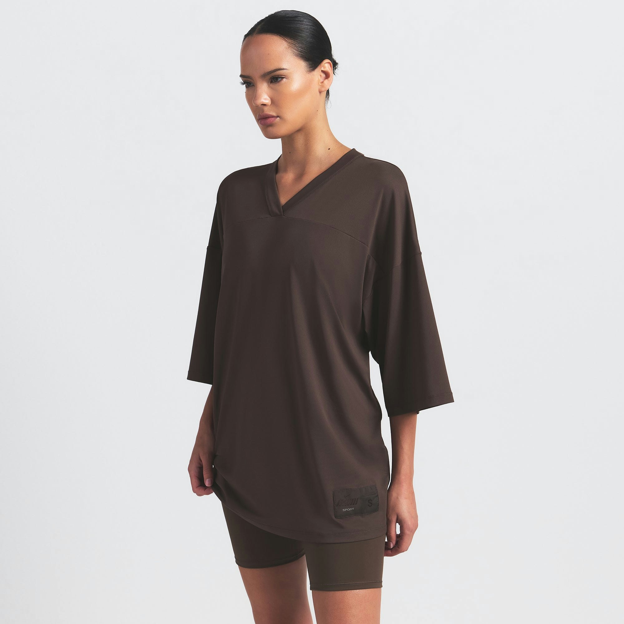 NikeSKIMS AIRY V-NECK OVERSIZED TOP | DARK SEPIA ON A MODEL SIDE VIEW @ | FOCUS: 0.9, 0.1, 0.7