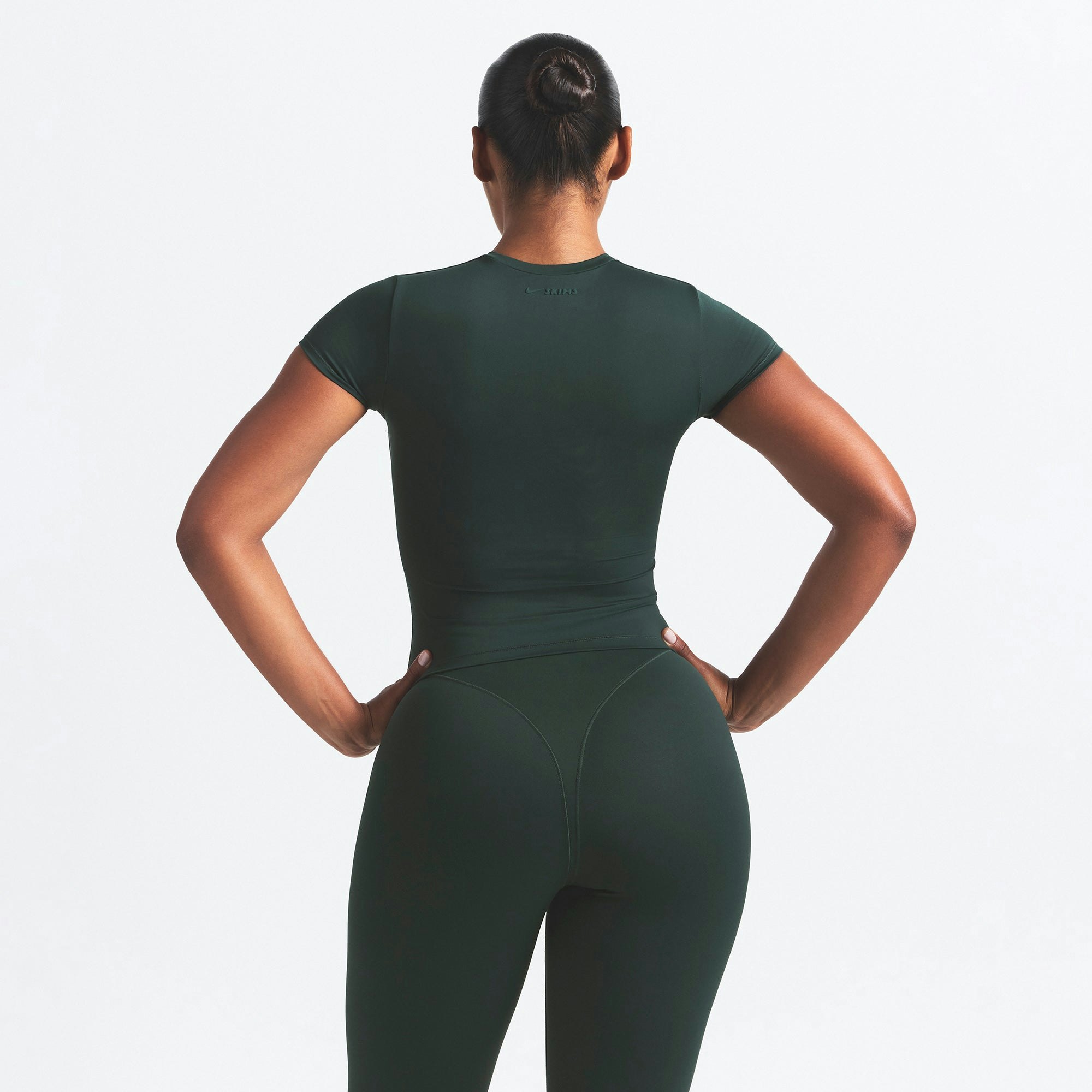 NikeSKIMS MATTE PADDED BABY TEE | DARK TEAL ON A MODEL SIDE VIEW @ | FOCUS: 0.0, 1.0, 0.9