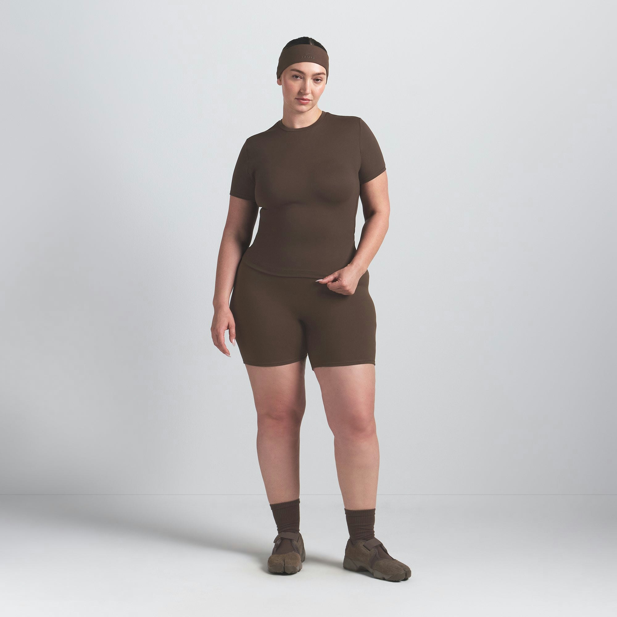 NikeSKIMS MATTE PADDED BABY TEE | DARK SEPIA ON A MODEL FRONT VIEW @ | FOCUS: 0.0, 1.0, 0.9