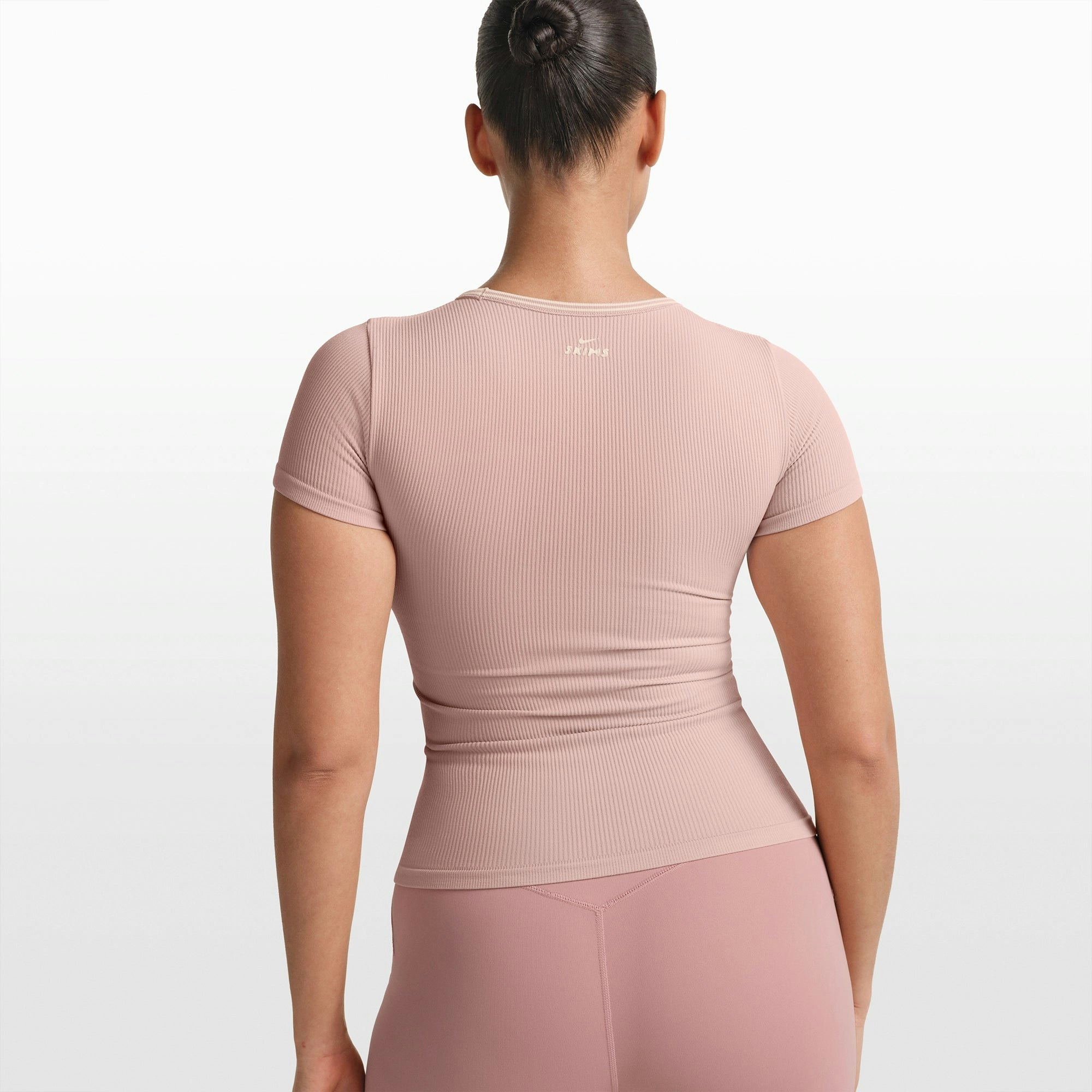 NikeSKIMS RIBBED SEAMLESS BABY TEE | HIMALAYAN/ECRU ON A MODEL FRONT VIEW @ | FOCUS: 0.0, 1.0, 0.9