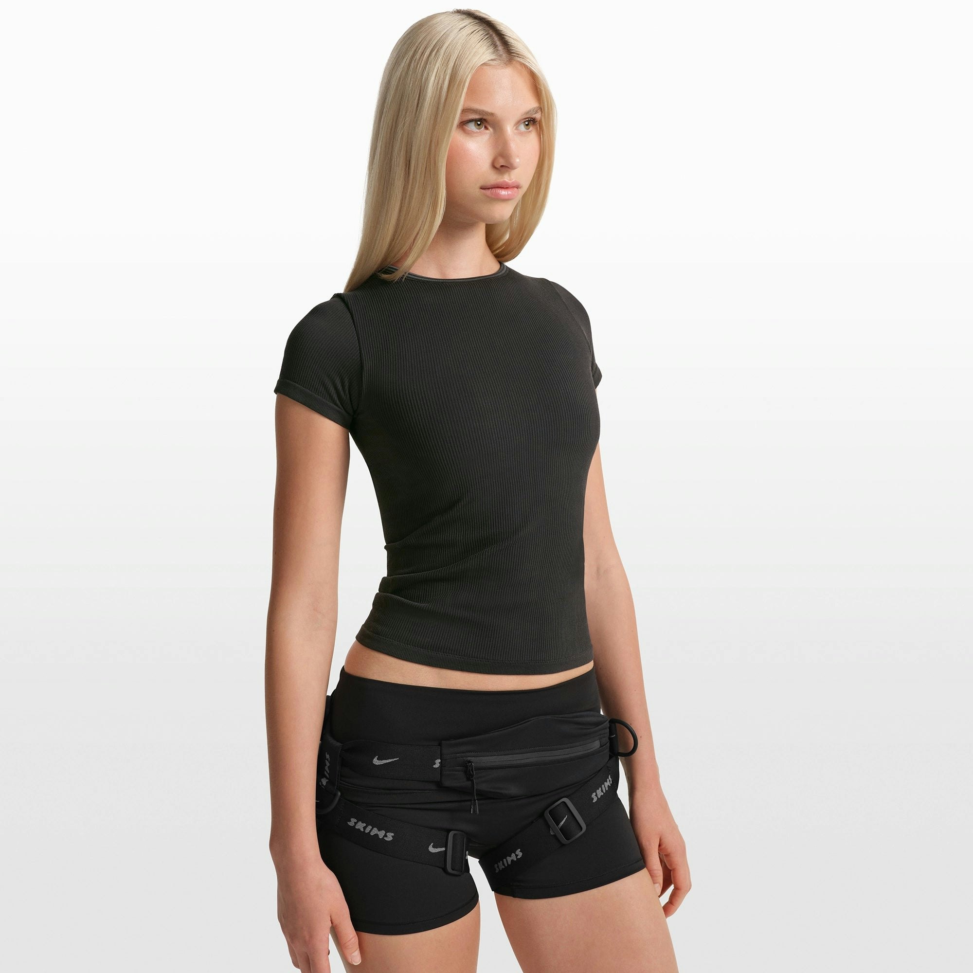 NikeSKIMS RIBBED SEAMLESS BABY TEE | OBSIDIAN/ARMOR ON A MODEL FRONT VIEW @ | FOCUS: 0.0, 1.0, 0.9
