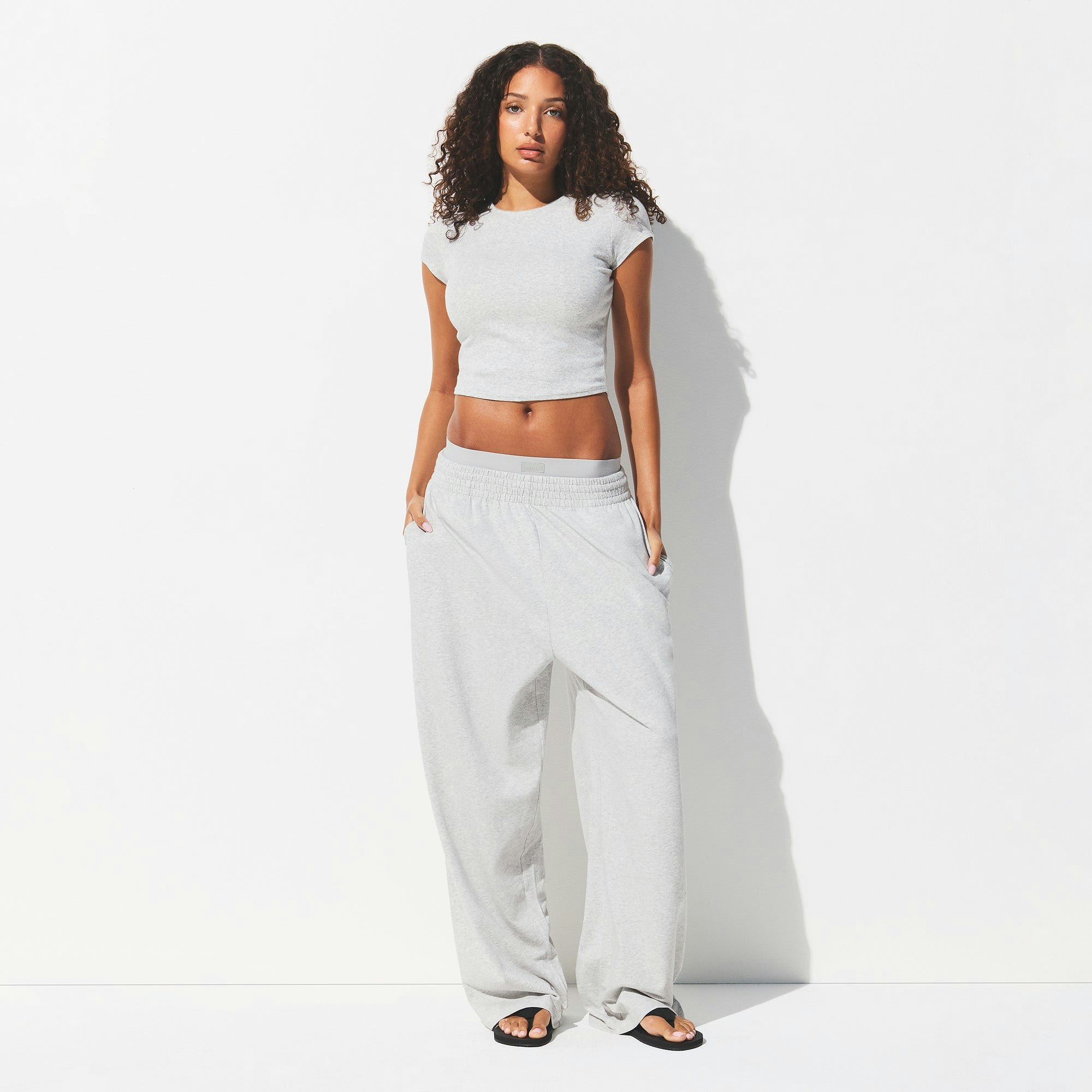 DROP NEEDLE POINTELLE BABY TEE | LIGHT HEATHER GREY ON A MODEL FRONT VIEW @ | FOCUS: 0.0, 1.0, 0.9