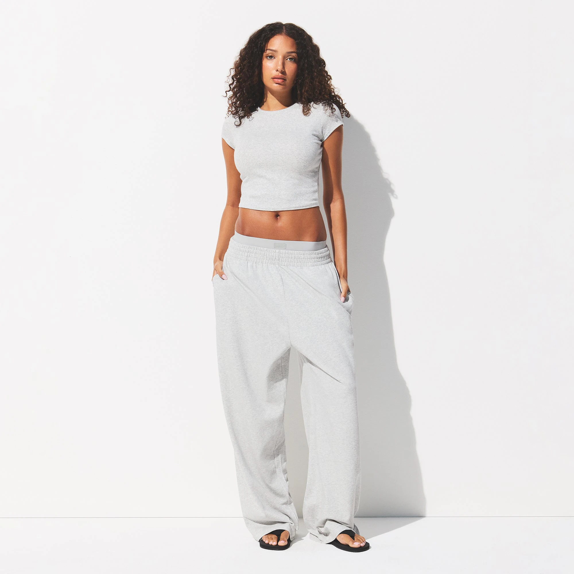 DROP NEEDLE POINTELLE BABY TEE | LIGHT HEATHER GREY ON A MODEL FRONT VIEW @ | FOCUS: 0.0, 1.0, 0.9