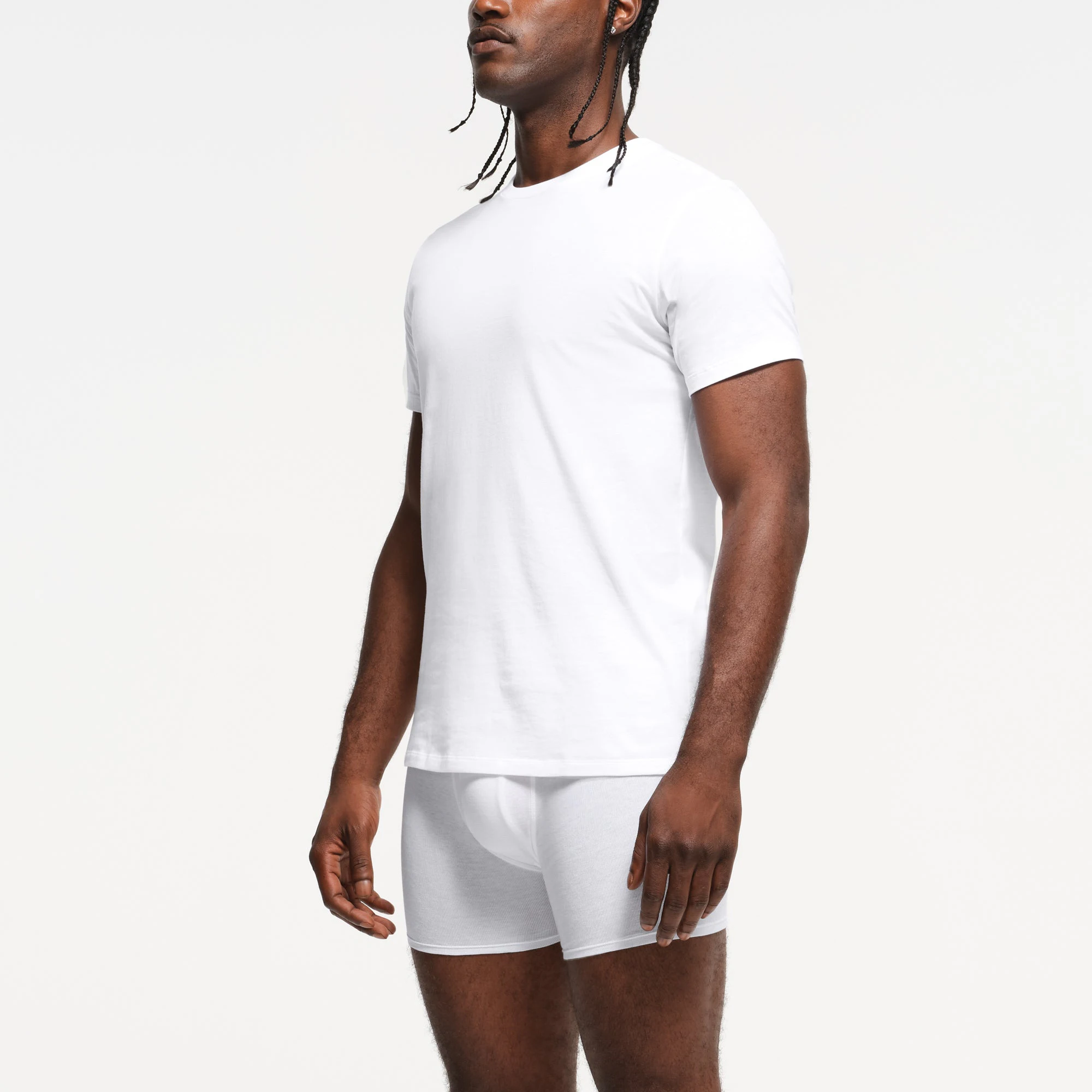 SKIMS BASICS MENS LIGHTWEIGHT T-SHIRT 3-PACK | CHALK ON A MODEL SIDE VIEW