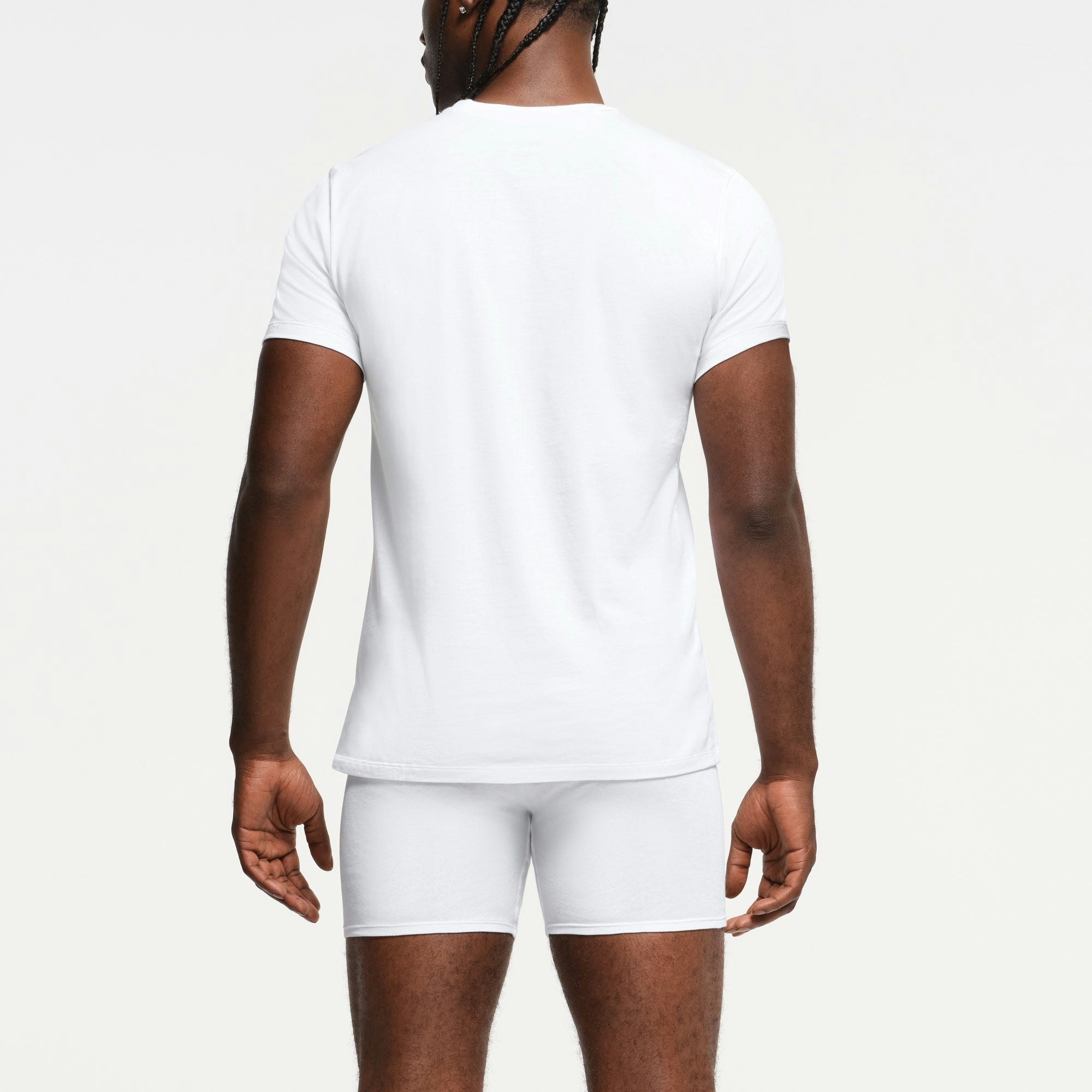 SKIMS BASICS MENS LIGHTWEIGHT T-SHIRT 3-PACK | CHALK ON A MODEL BACK VIEW