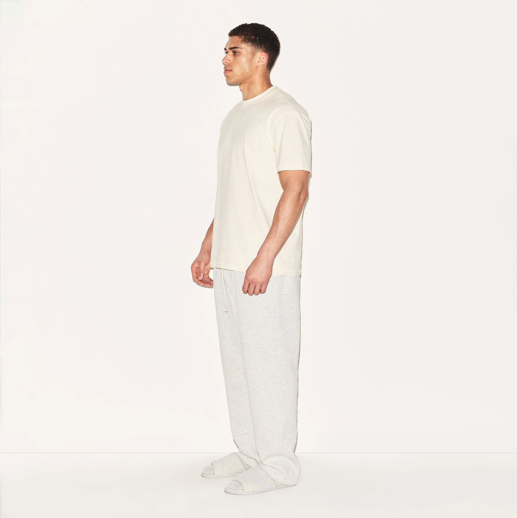 HEAVYWEIGHT COTTON MENS RELAXED T-SHIRT | ECRU ON A MODEL SIDE VIEW | FOCUS: 0.0, 1.0, 0.9