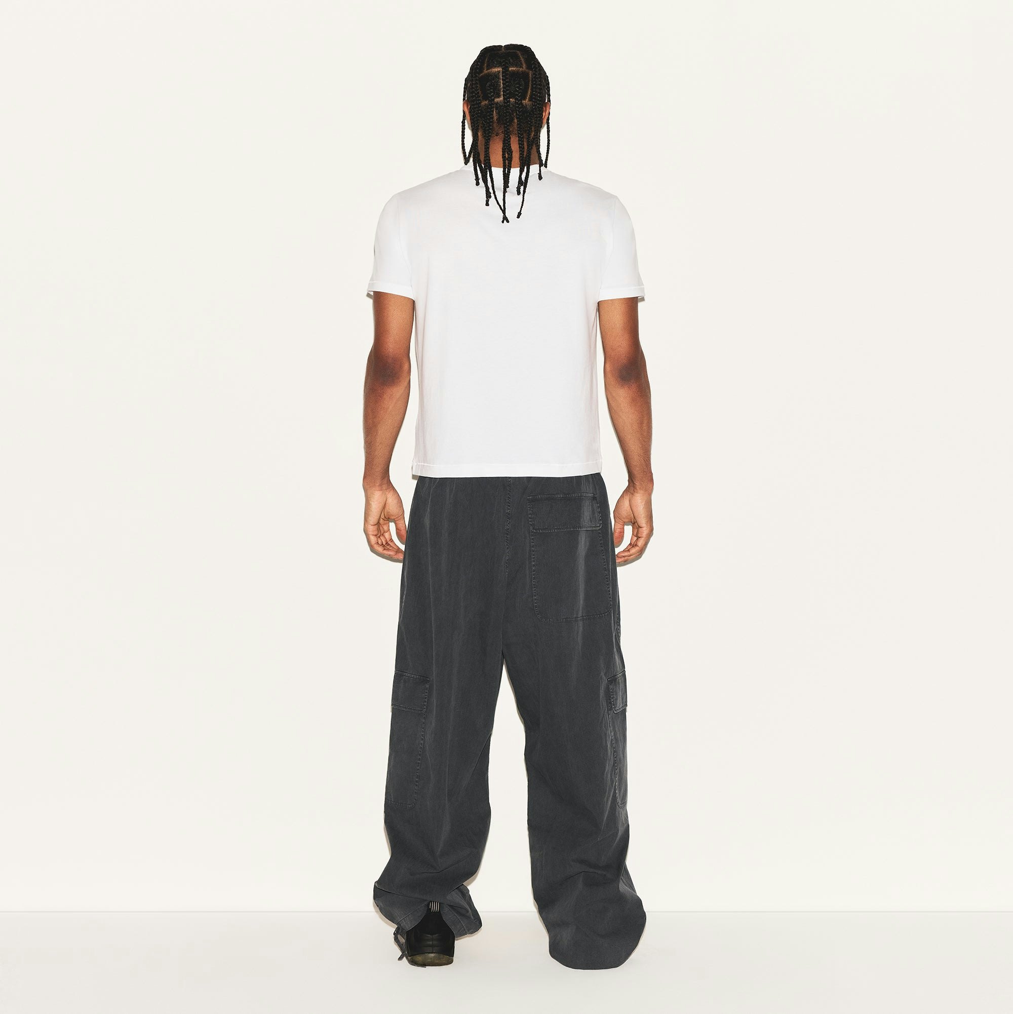 SKIMS COTTON MENS SLIM CROPPED T-SHIRT | CHALK ON A MODEL BACK VIEW | FOCUS: 0.0, 1.0, 0.9