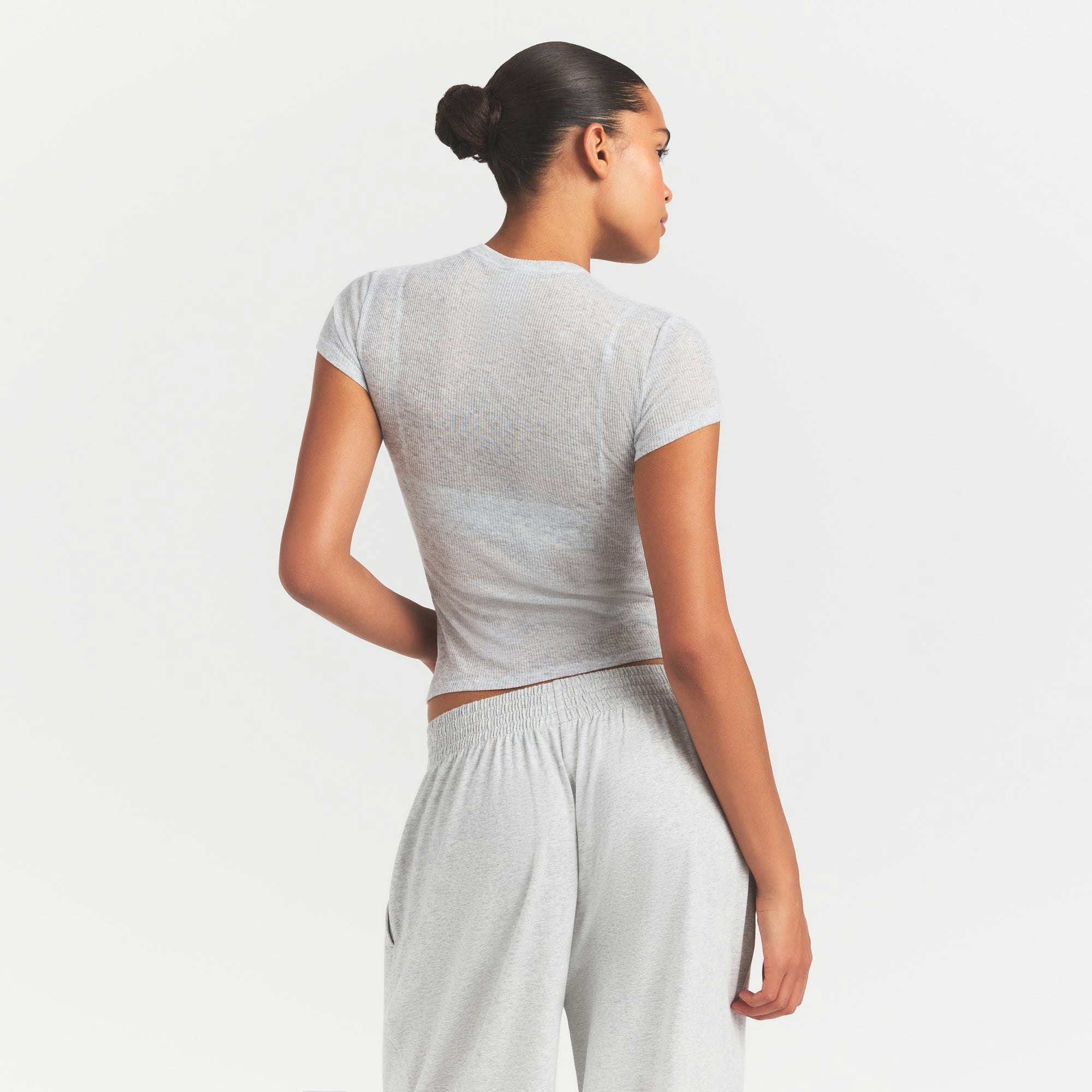 SHEER RIB T-SHIRT | LIGHT HEATHER GREY ON A MODEL SIDE VIEW @ | FOCUS: 0.0, 1.0, 0.9