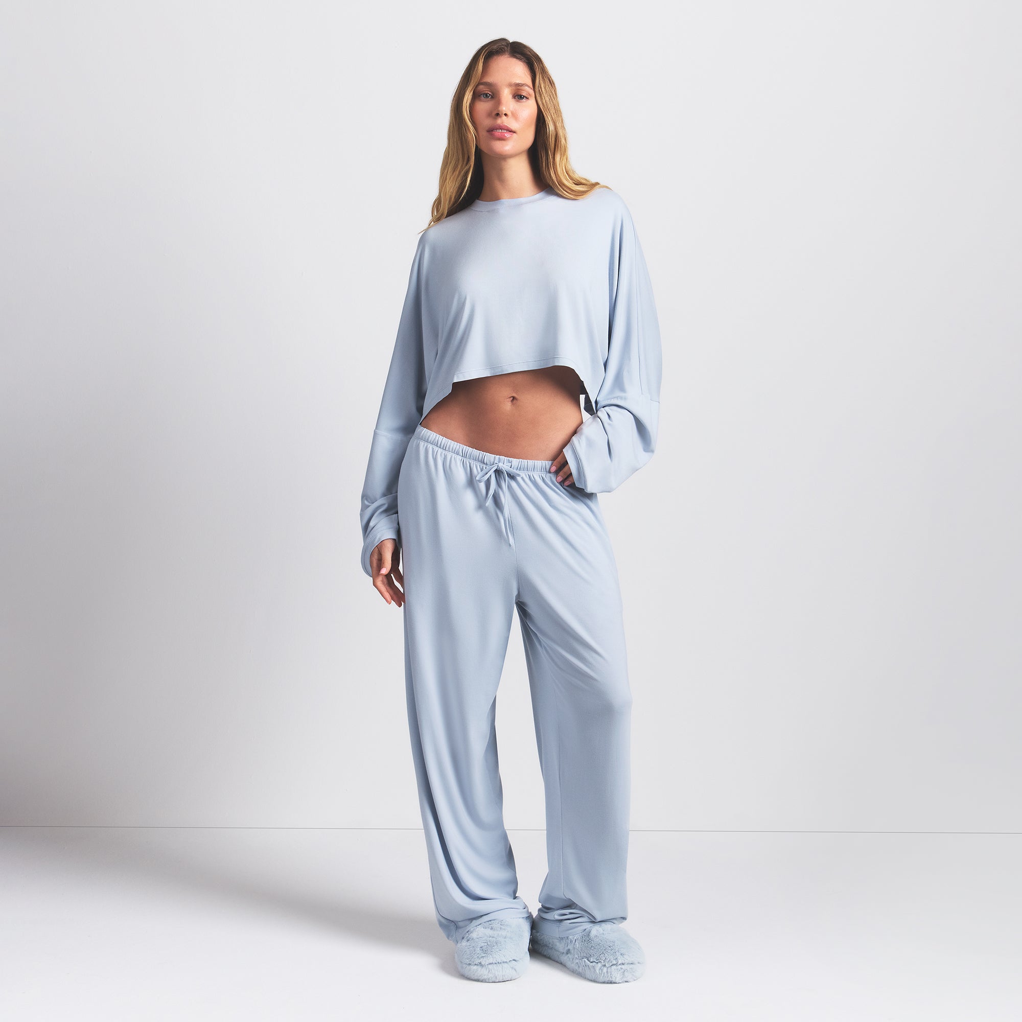SKIMS SLEEP CROPPED LONG SLEEVE AND PANT SET | ZEN BLUE ON A MODEL FRONT VIEW @ | FOCUS: 0.0, 1.0, 0.9