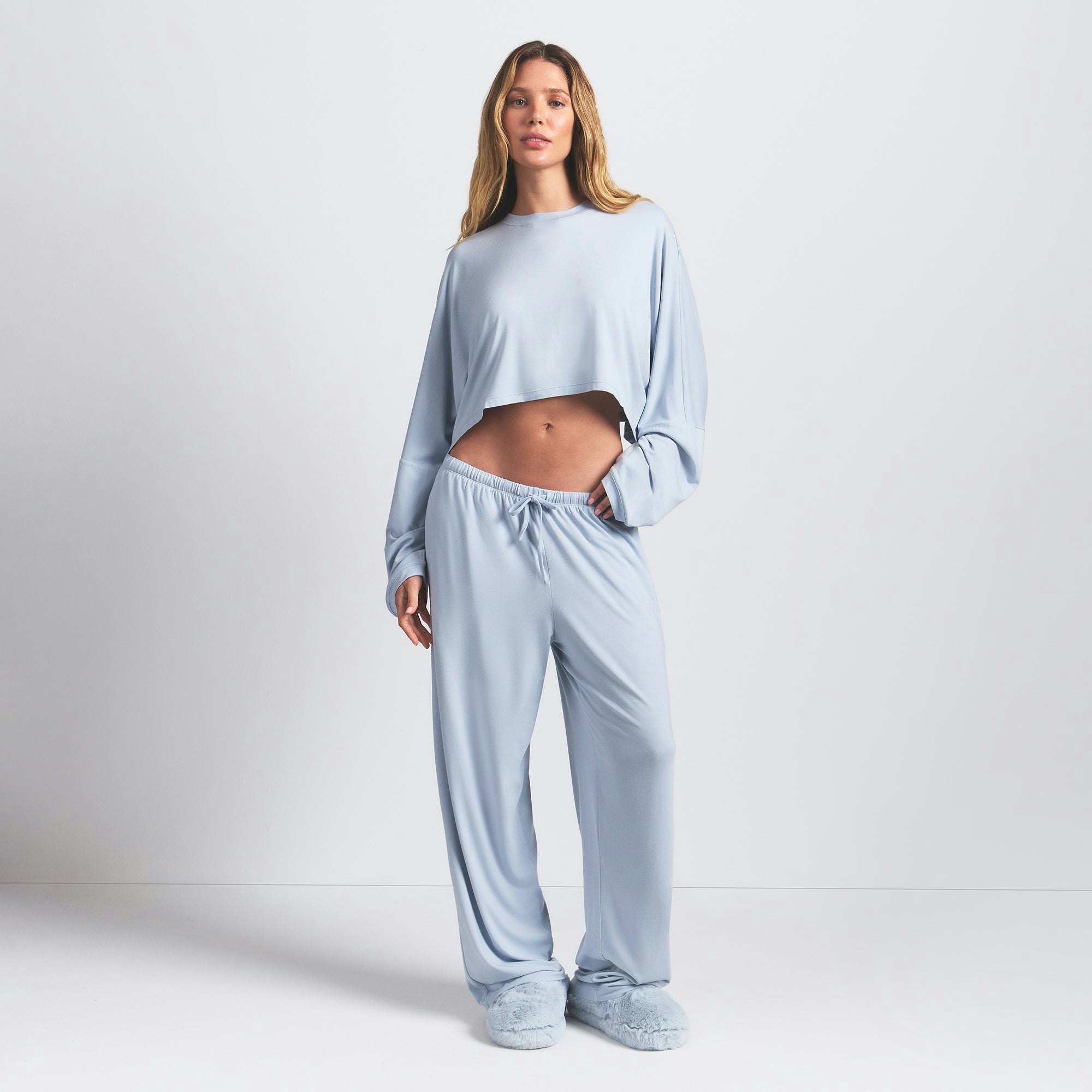 SKIMS SLEEP CROPPED LONG SLEEVE AND PANT SET | ZEN BLUE ON A MODEL FRONT VIEW @ | FOCUS: 0.0, 1.0, 0.9
