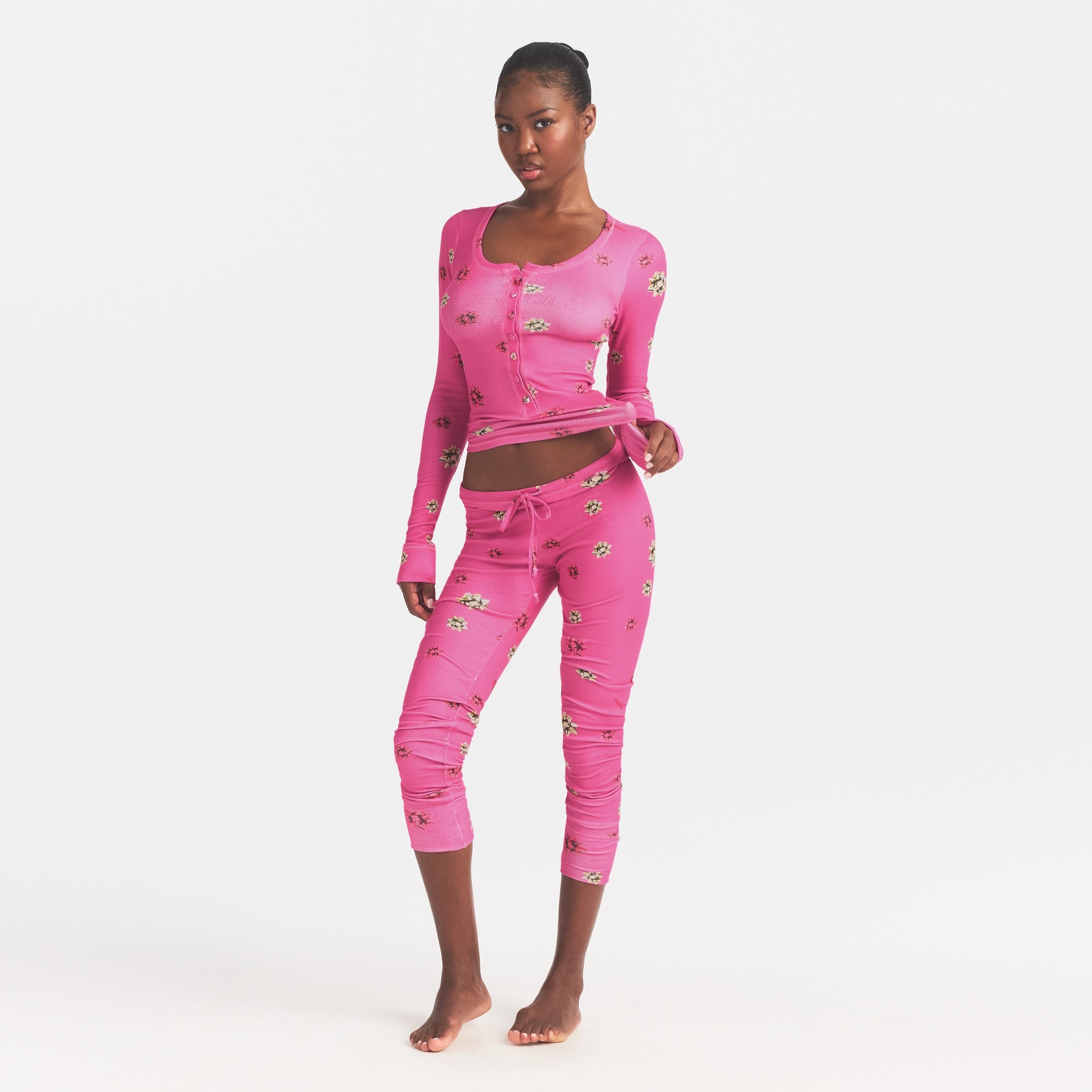 LOGO PLUSH POINTELLE TANK AND LOOSE PANT SET | HOT PINK GIFT BOWS ON A MODEL FRONT VIEW @ | FOCUS: 0.0, 1.0, 0.9