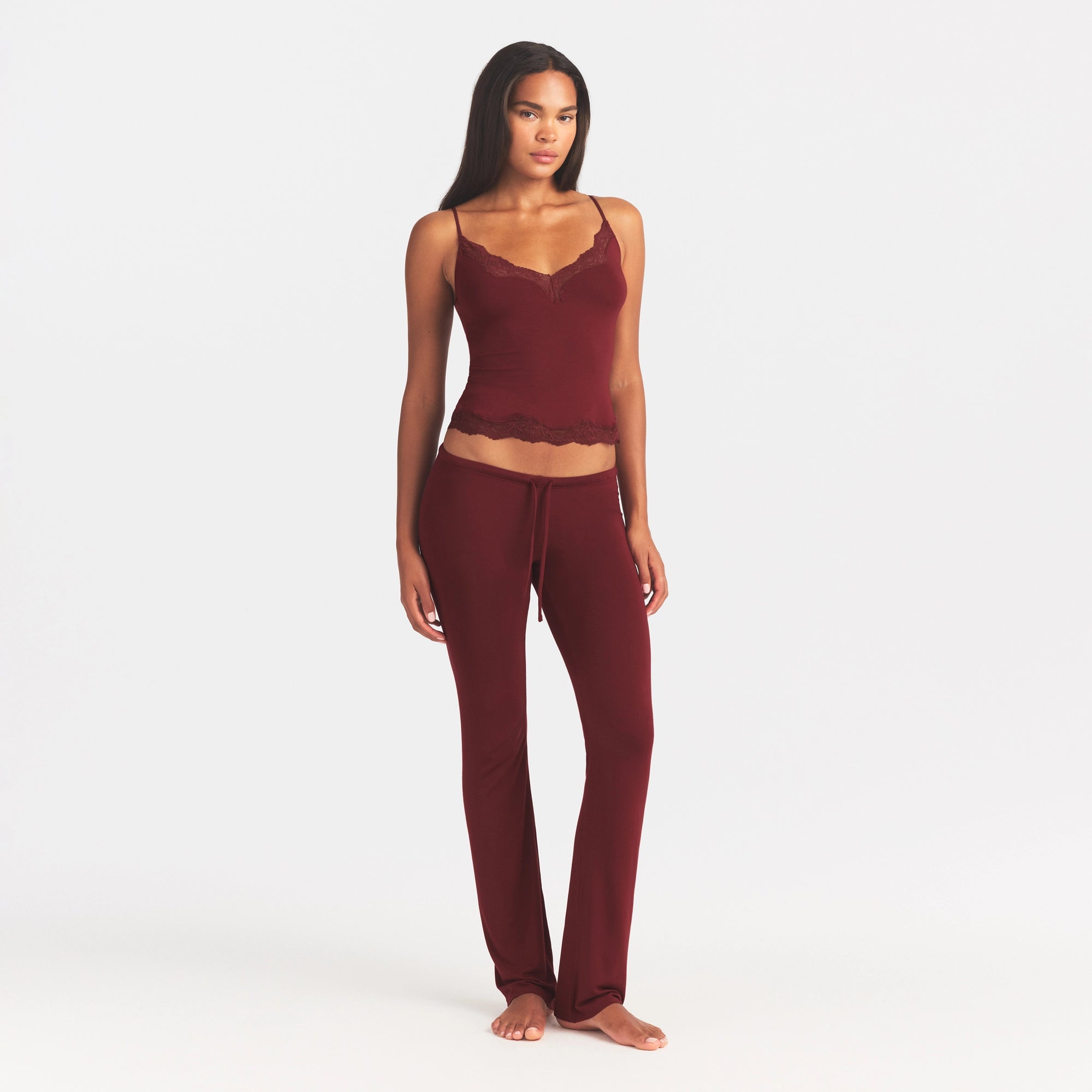 SKIMS SLEEP LACE CAMI AND PANT SLEEP SET | MERLOT ON A MODEL FRONT VIEW @ | FOCUS: 0.0, 1.0, 0.9